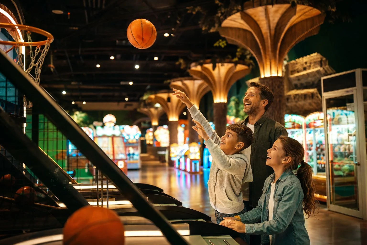 Family playing an arcade game smiling