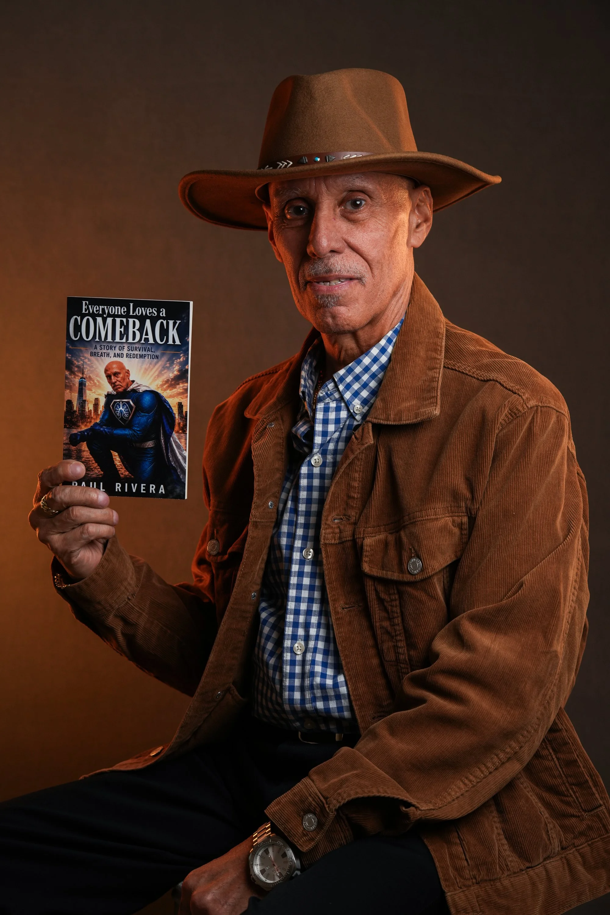 Paul Rivera, pulmonary fibrosis survivor and author, holding his book Everyone Loves a Comeback