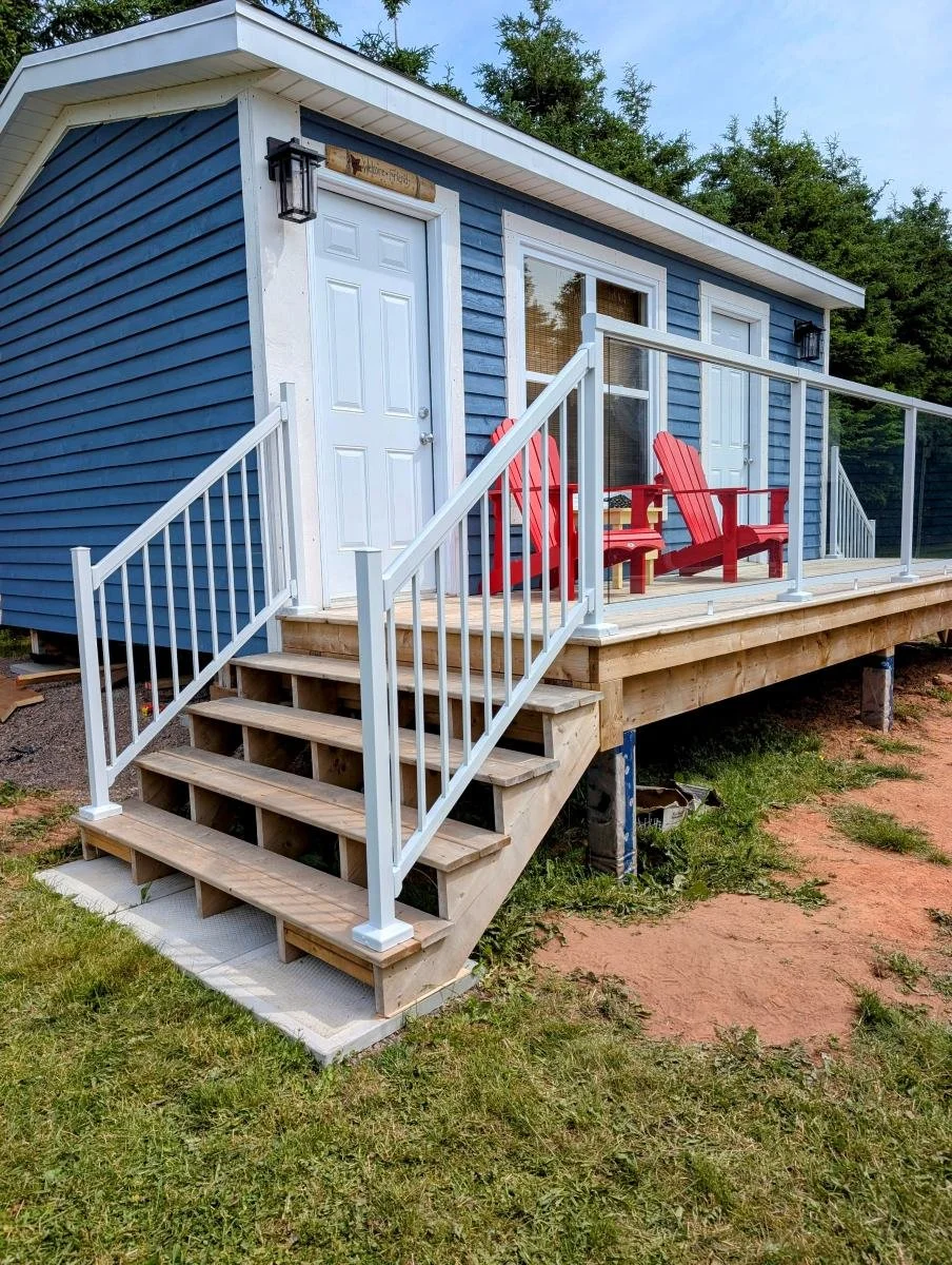 Custom designed and built glass and white aluminum railings for cottage owner in Long River, PEI.