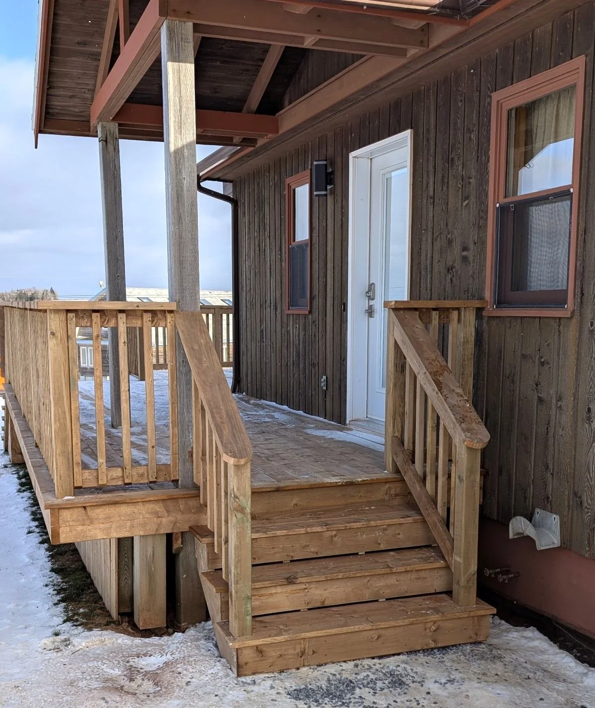 Custom design and built, pressure treated, wooden deck with stairs and wood railing built for homeowner in Stanley Bridge, PEI