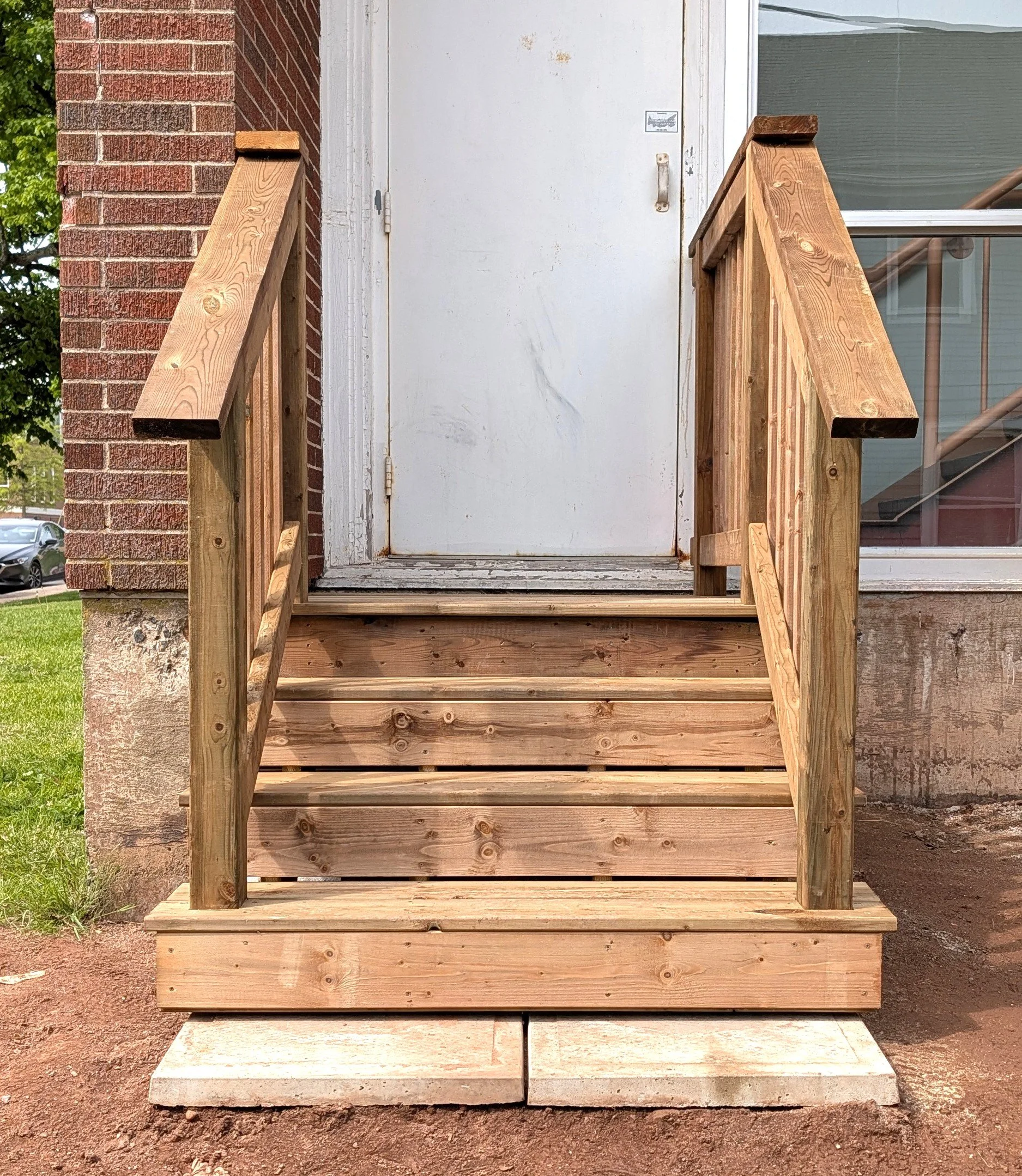 Custom design and built, pressure treated wooden, emergency exit stairs built for business in Charlottetown, PEI