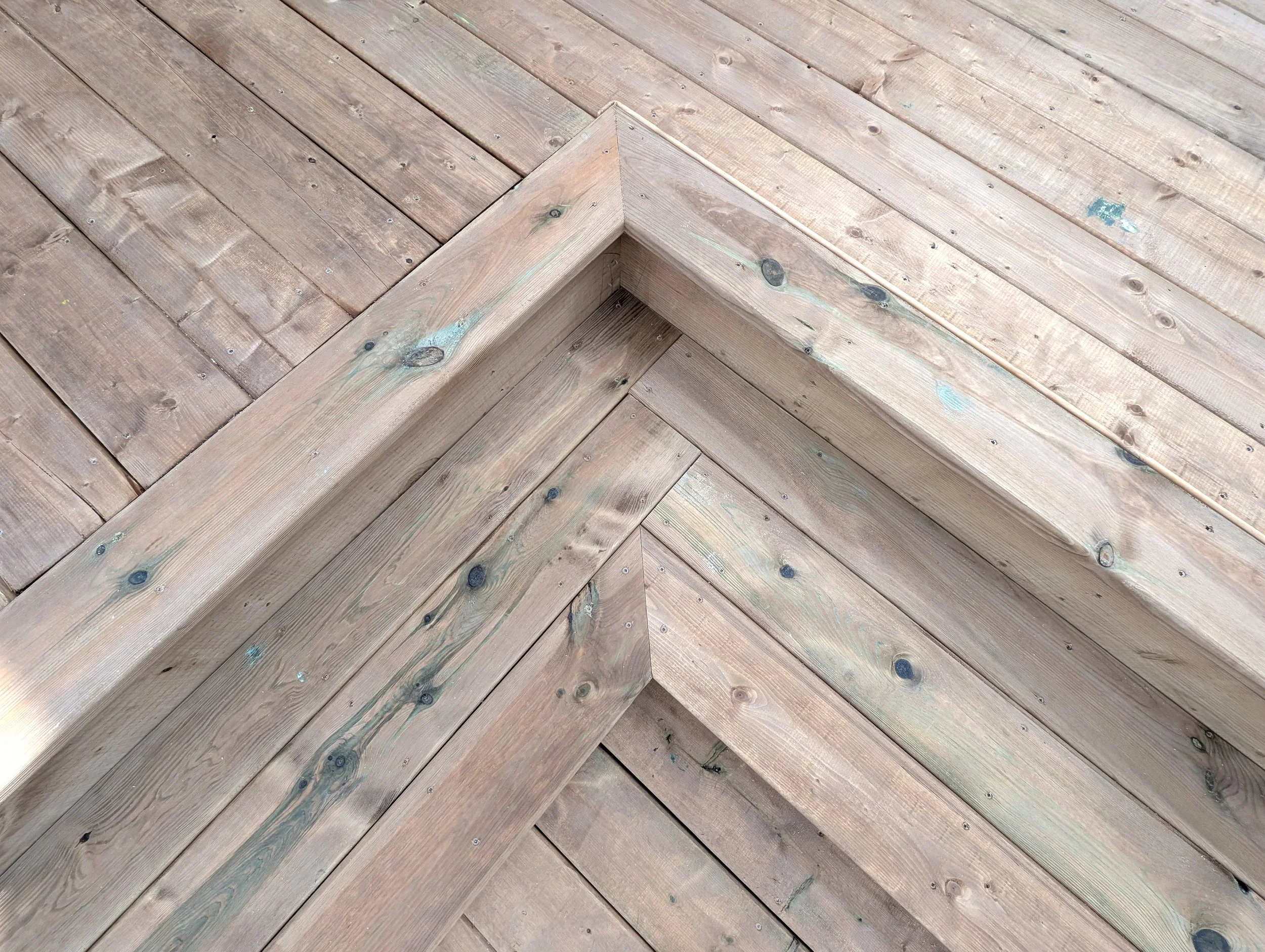 Custom design and built, pressure treated, multi level wooden deck with corner stairs built for homeowner in West Covehead, PEI