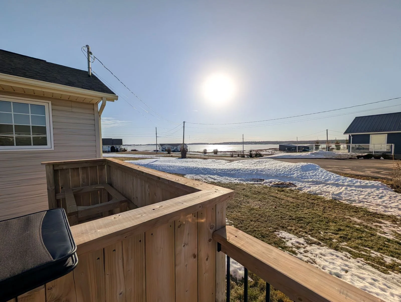 Custom designed and built pressure treated wood railings on deck for cottage owner in Stanley Bridge, PEI.