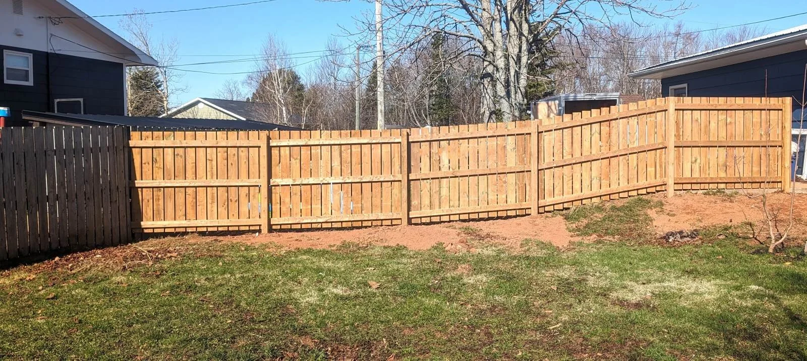 Custom pressure-treated wooden fence built in Charlottetown, PEI
