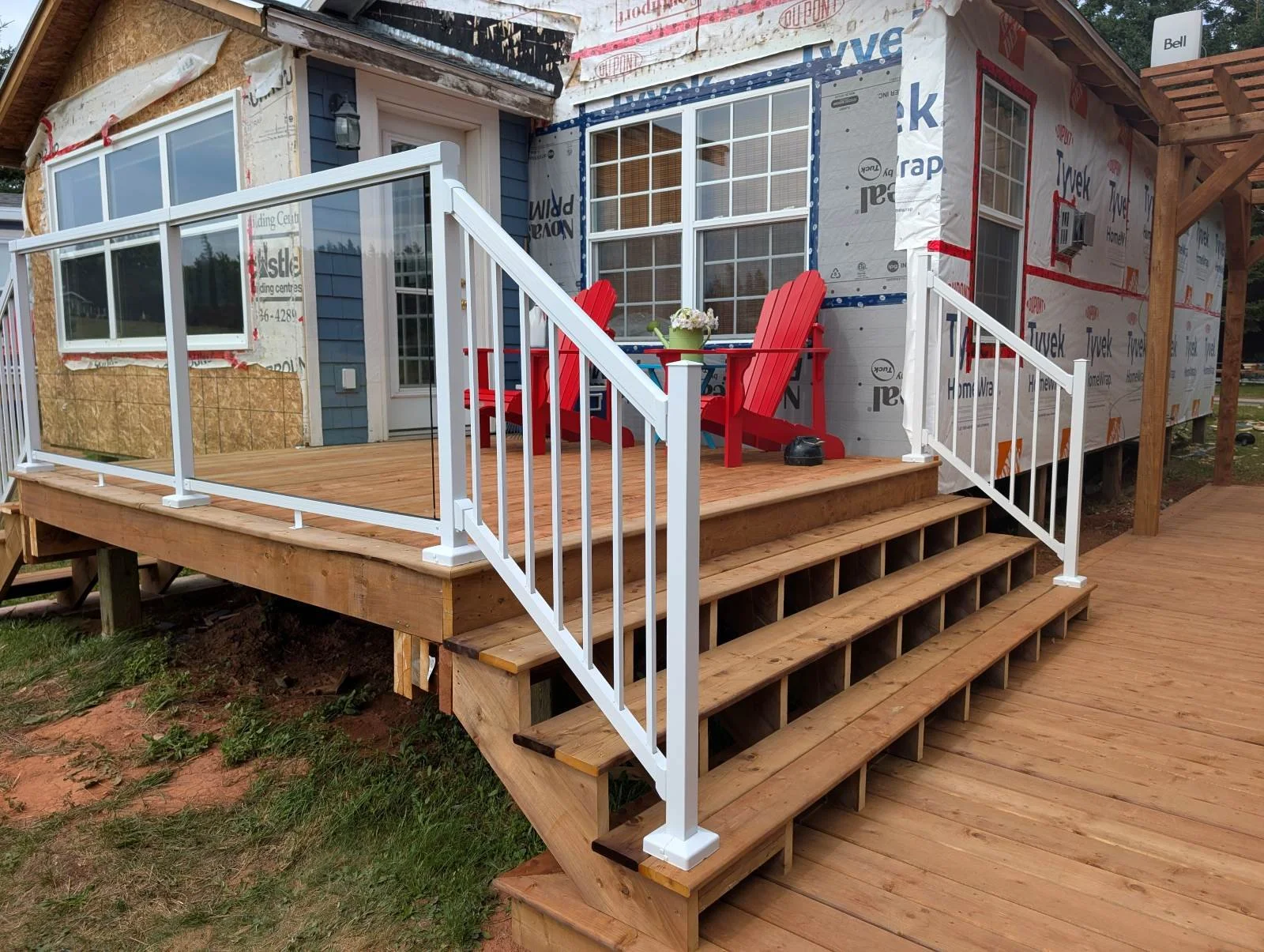Custom designed and built glass and white aluminum railings for cottage owner in Long River, PEI.