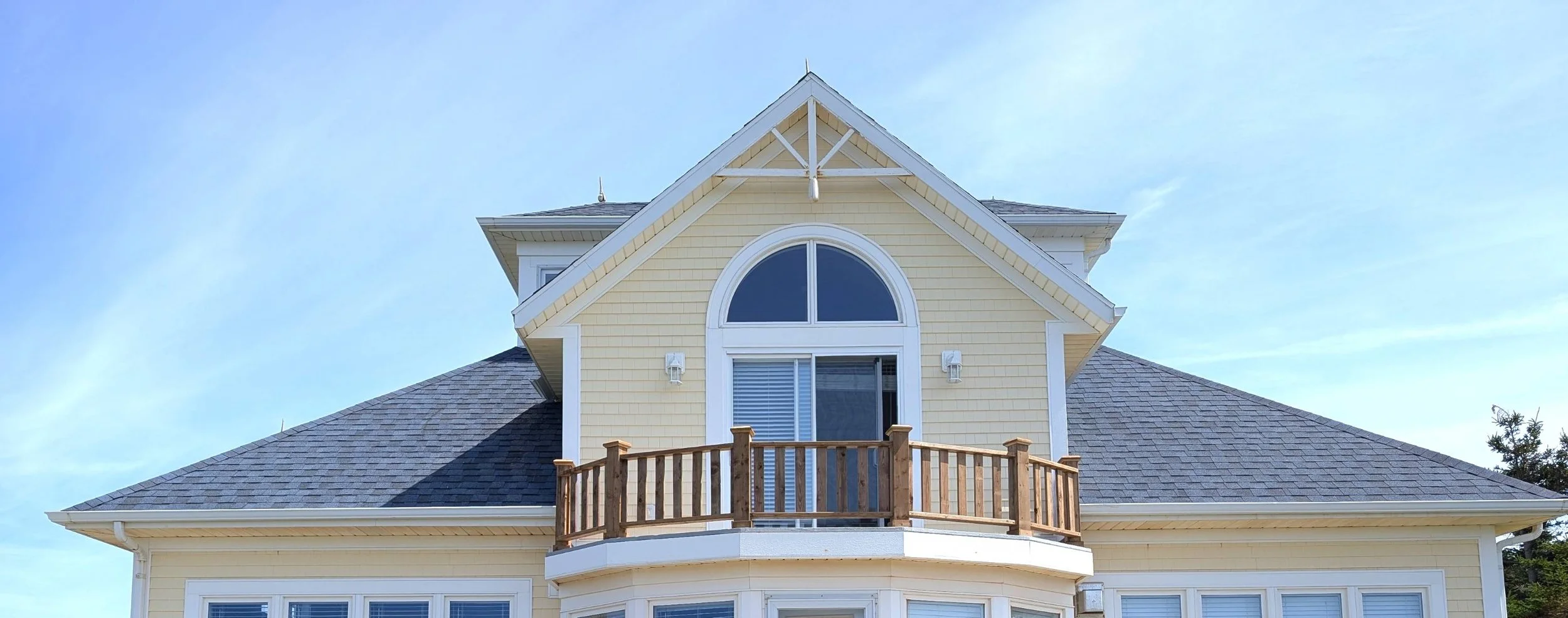 Custom built, pressure treated wood railings on upper level, walk-out deck, built for a cottage owner in Canoe Cove, PEI