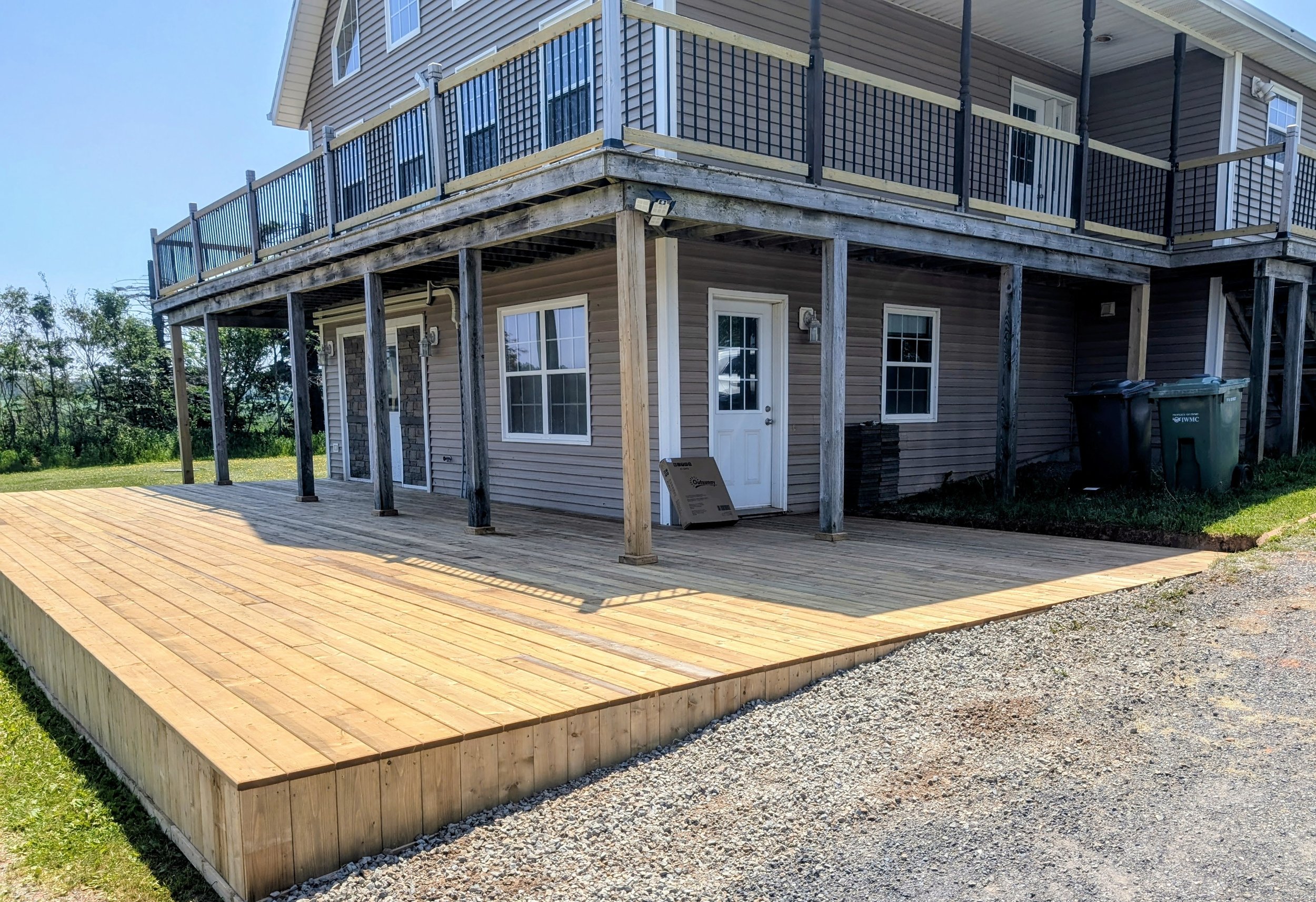 Custom built, pressure treated, ground level wooden deck built for a homeowner in North Rustico, PEI.