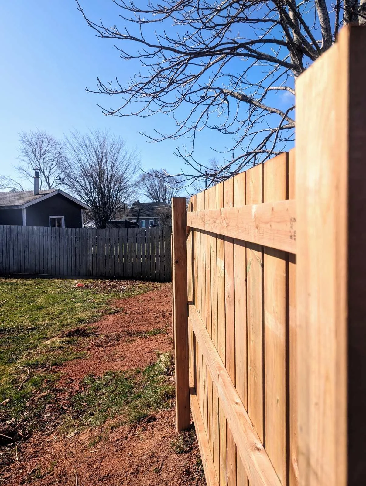 Custom pressure-treated wooden fence built in Charlottetown, PEI