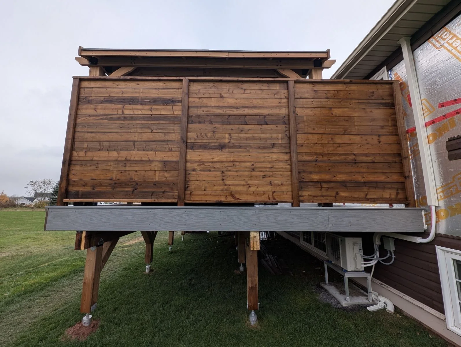 Custom pressure-treated wooden privacy wall on a composite deck built in Charlottetown, PEI