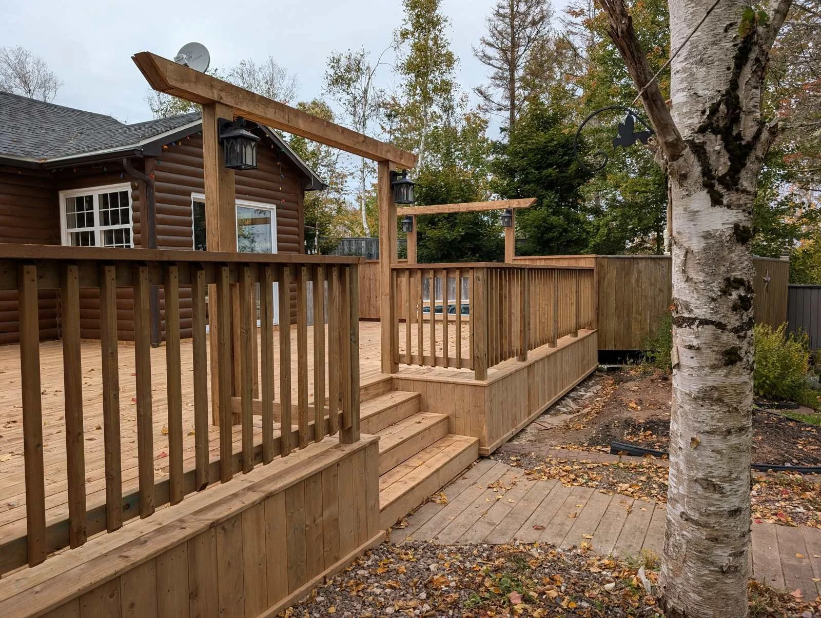 Custom designed and built pressure treated wood railings on deck for homeowner in Hunter River, PEI.