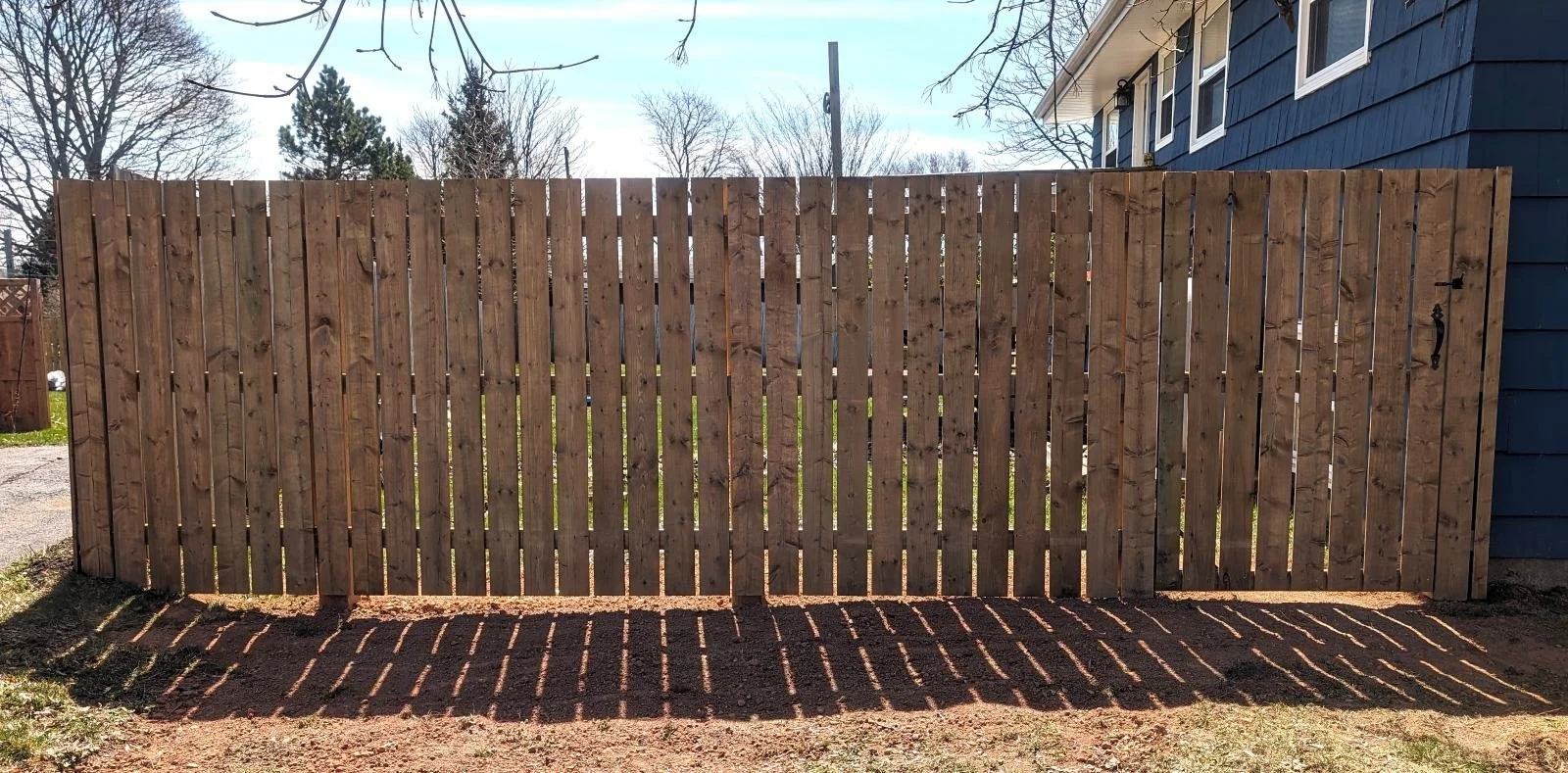 Custom pressure-treated wooden fence built in Charlottetown, PEI