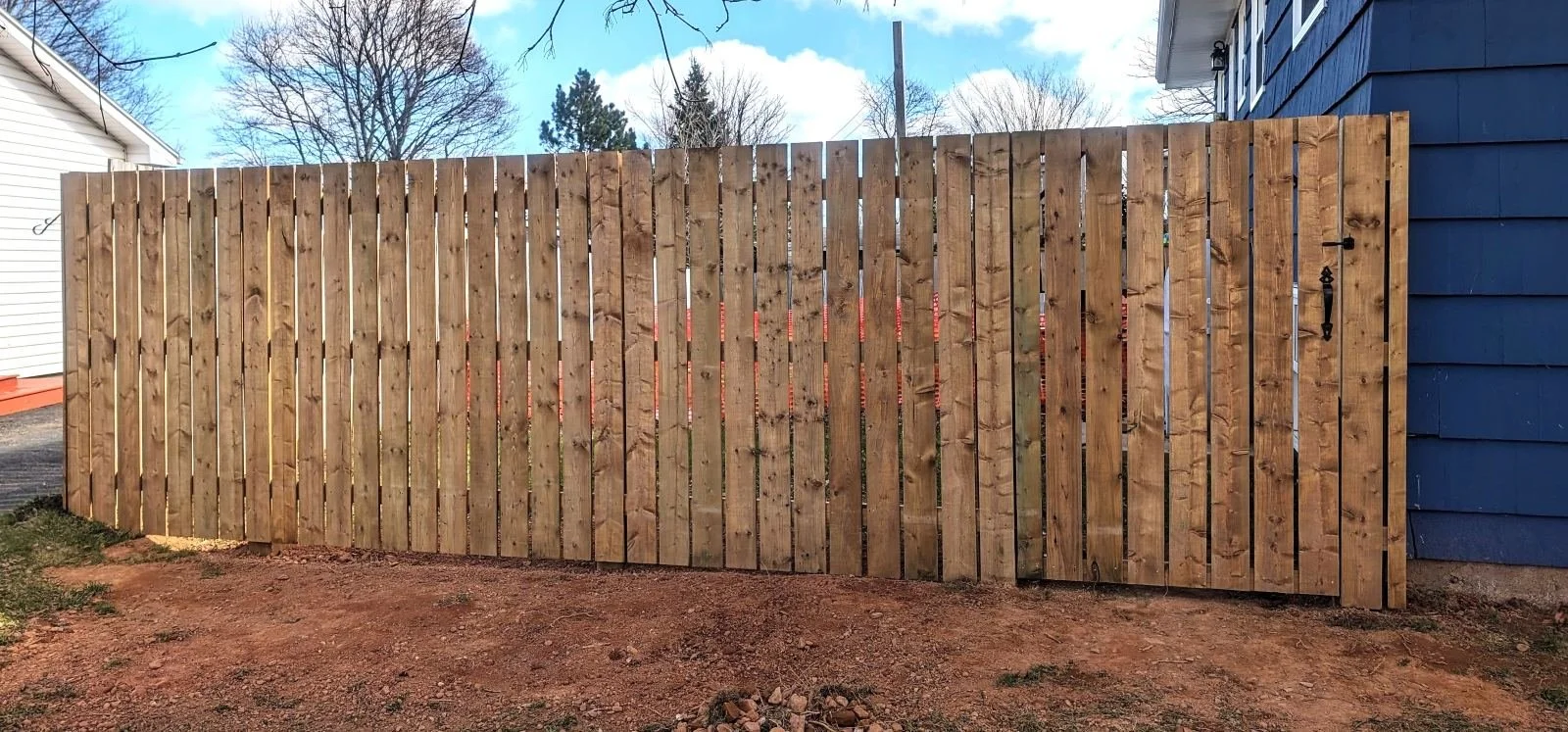 Custom pressure-treated wooden fence built in Charlottetown, PEI