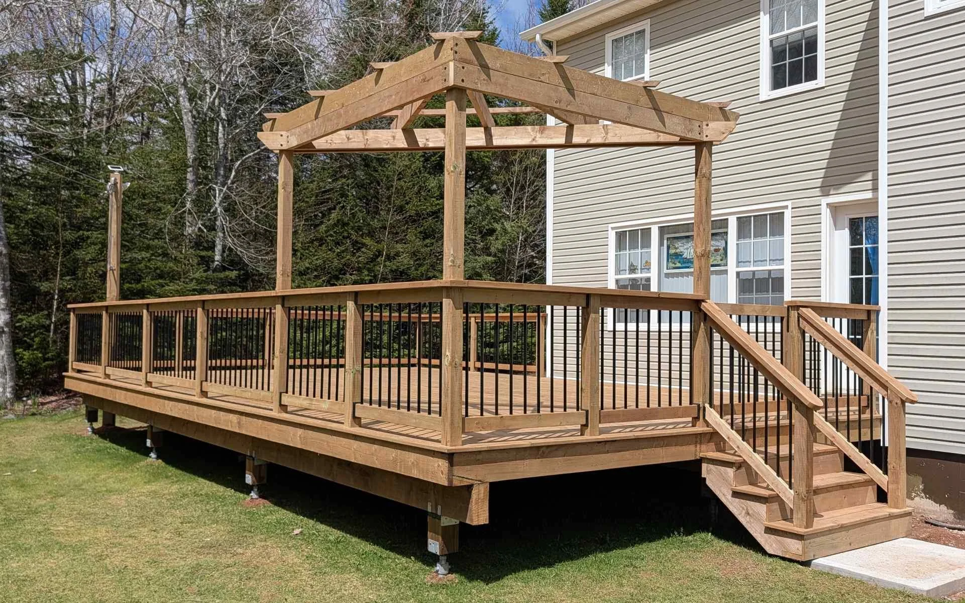 Custom design pressure treated corner wood pergola built for a homeowner in Brackely Beach, PEI 