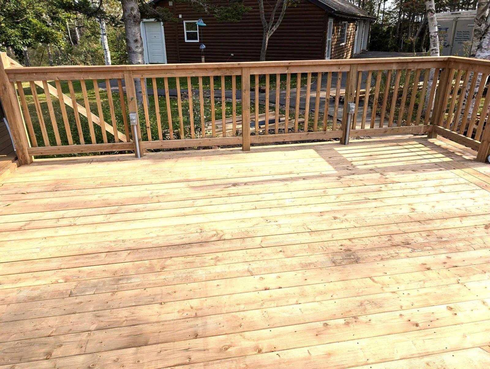 Custom designed and built pressure treated wood railings on deck for homeowner in Hunter River, PEI.