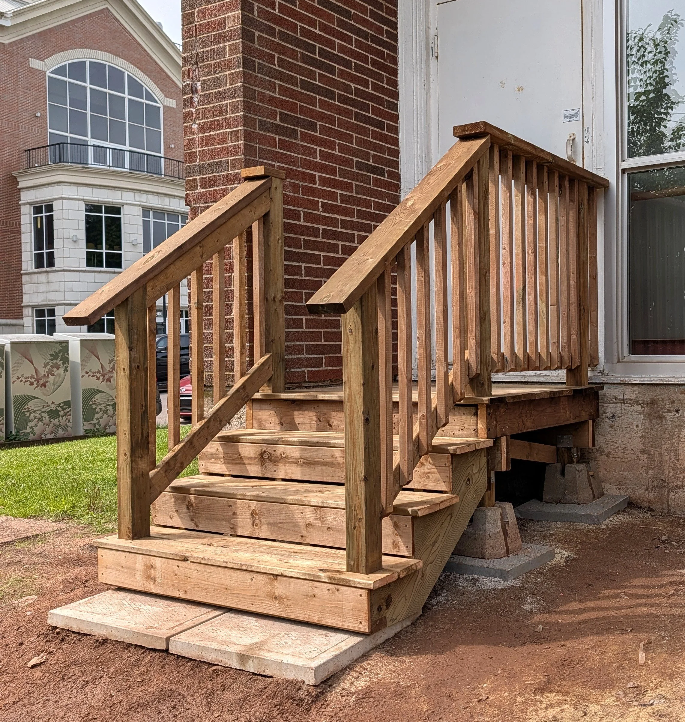 Custom design and built, pressure treated wooden, emergency exit stairs built for business in Charlottetown, PEI