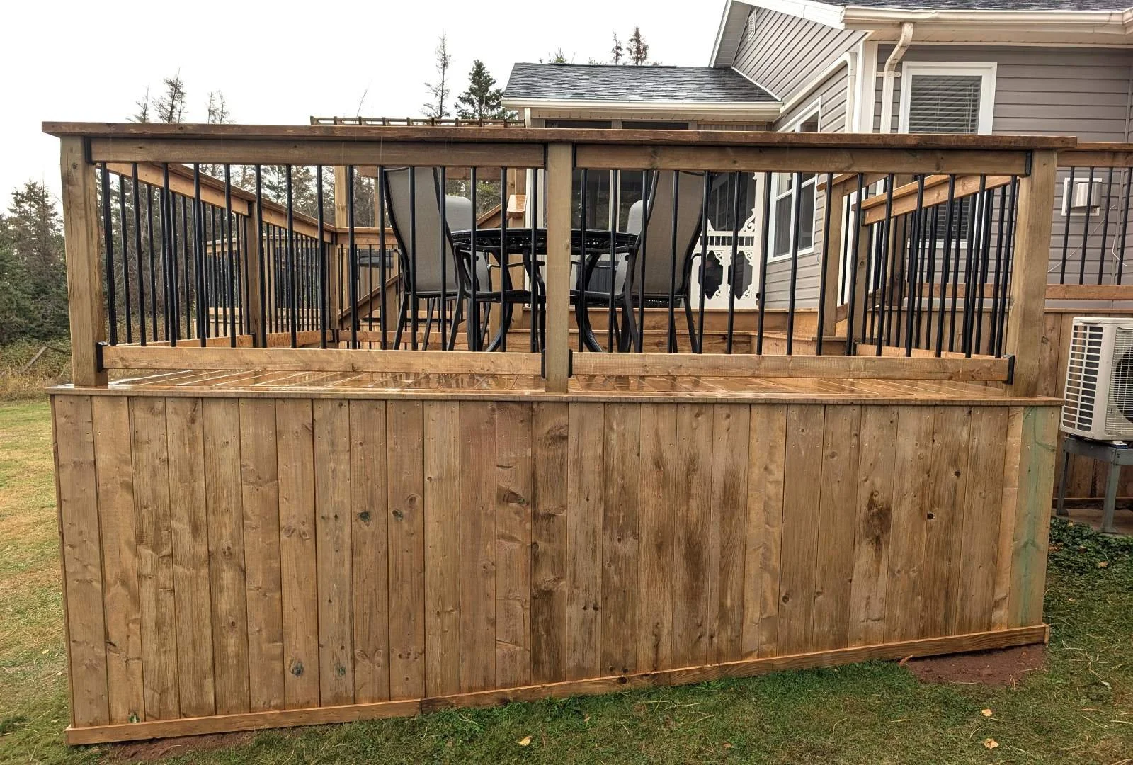 Custom built, pressure treated wood multi-level deck with dining area overlooking the water,  built for a home owner in West Covehead, PEI
