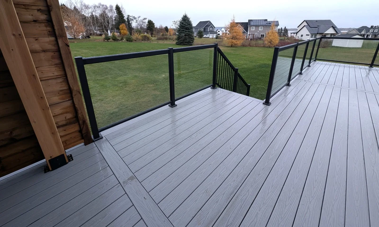 Custom designed and built glass and black aluminum railings on composite deck built for home owner in Cornwall, PEI.