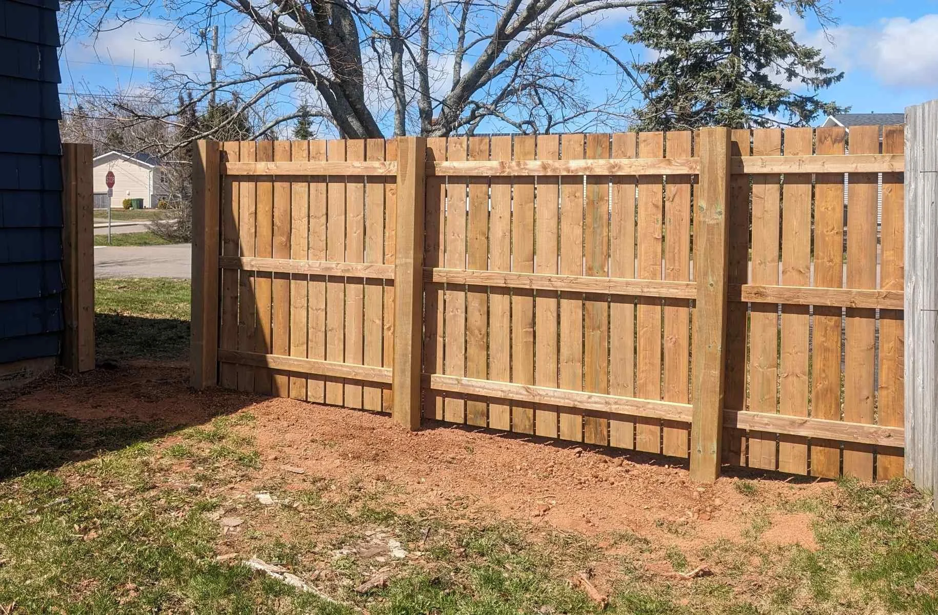 Custom pressure-treated wooden fence built in Charlottetown, PEI