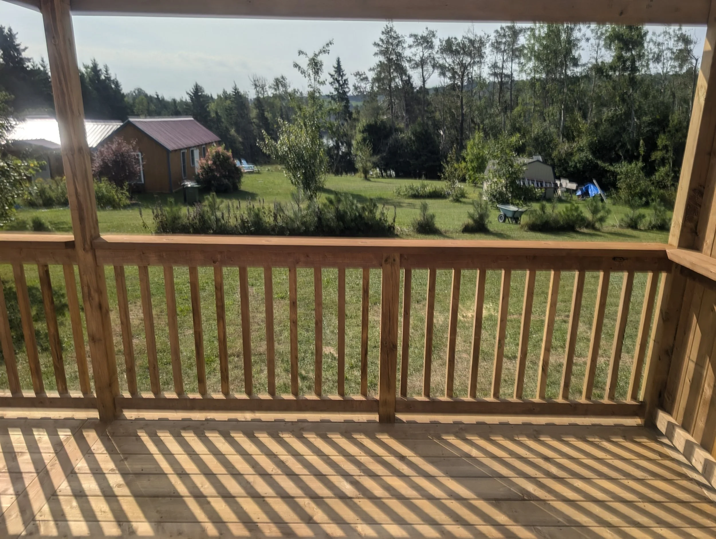 Custom designed and built pressure treated wood railings on deck for cottage owner in Stanley Bridge, PEI.