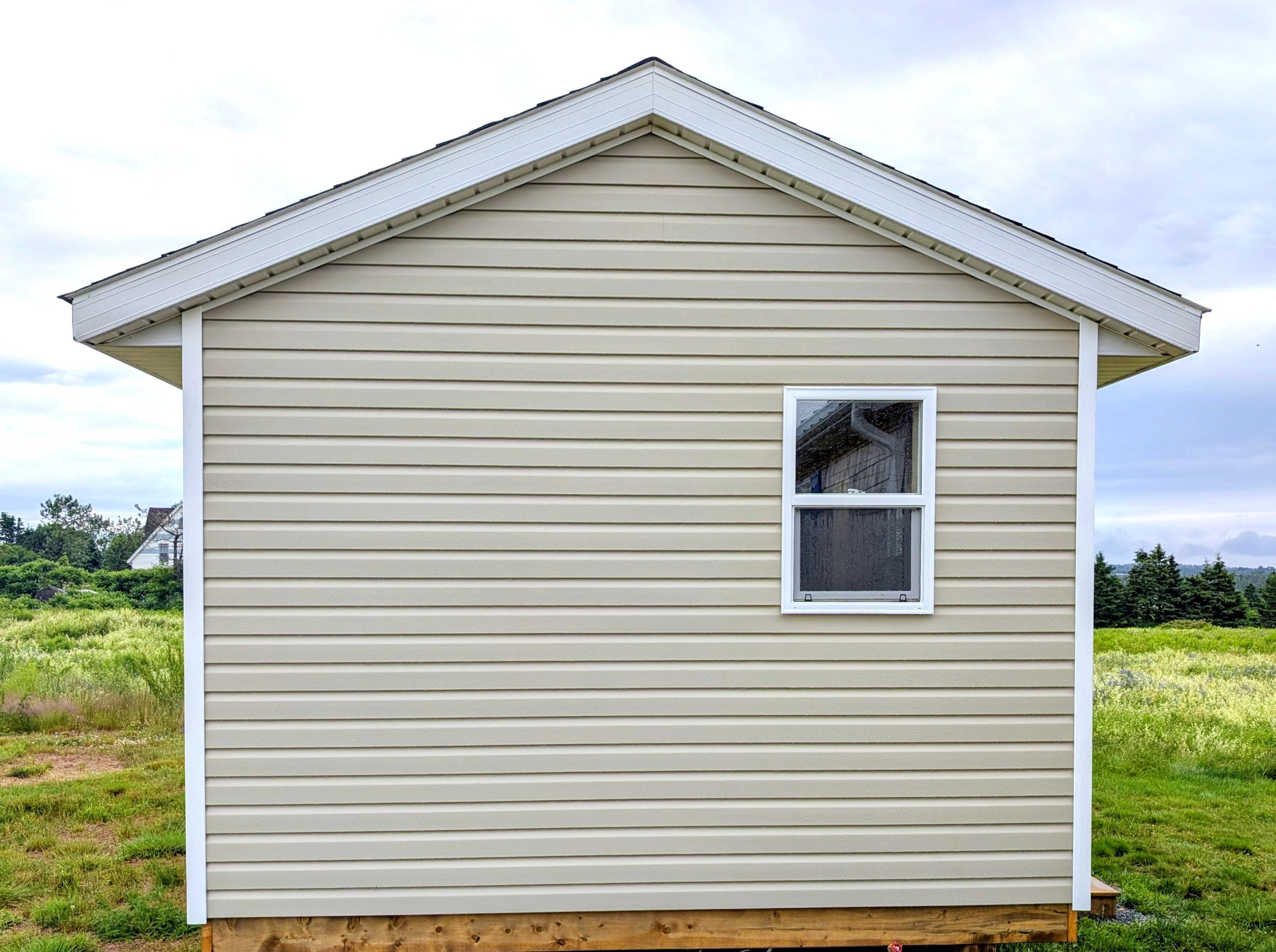 Custom designed and built detached 12 x 16 Bunk House with vinyl siding built for cottage owner in Canoe Cove, PEI.