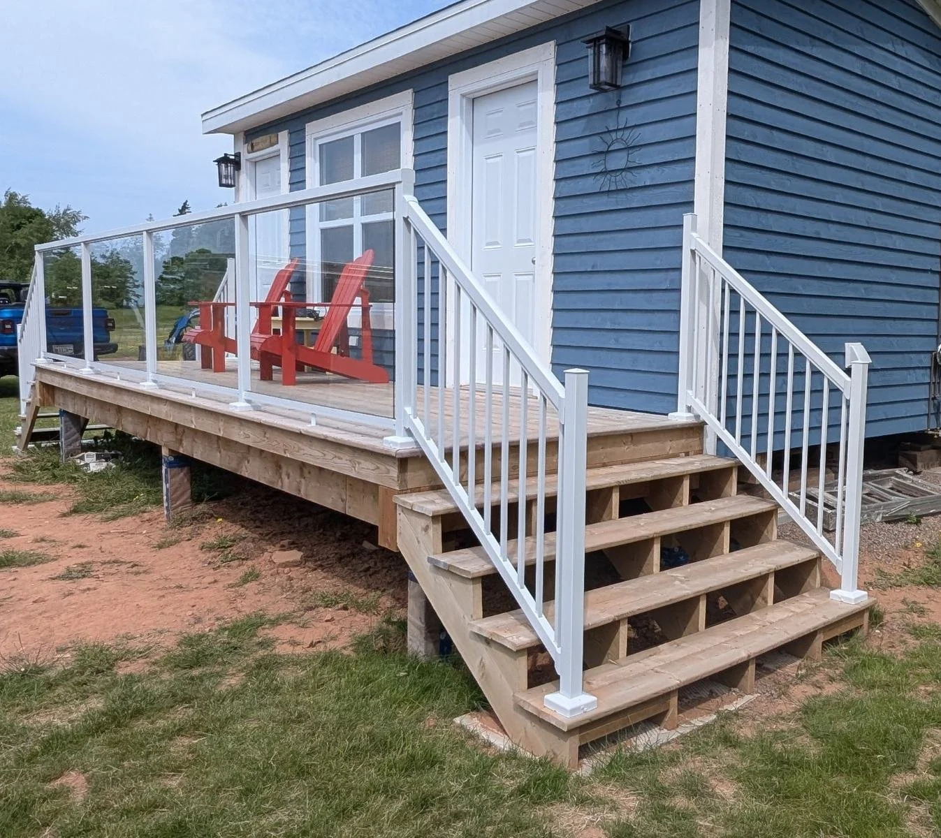 Custom designed and built glass and white aluminum railings for cottage owner in Long River, PEI.
