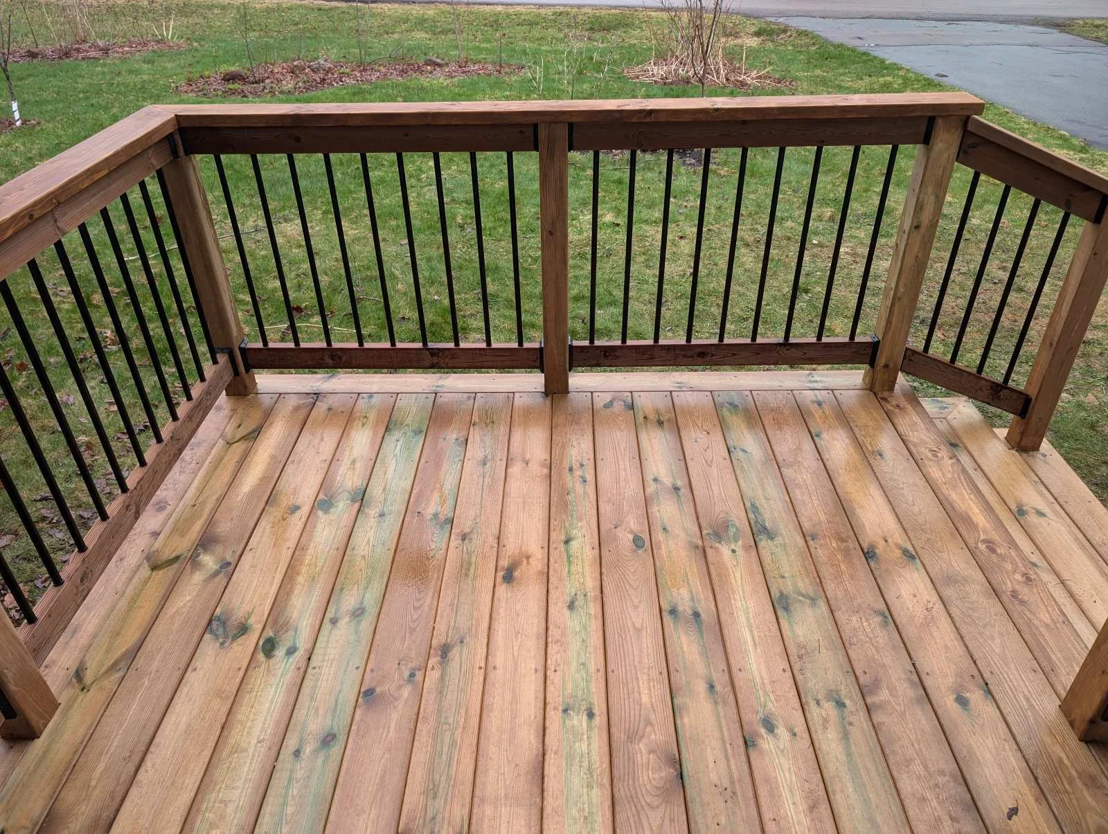 Custom designed and built pressure treated wood and black aluminum railings on front step built for home owner in Charlottetown, PEI.