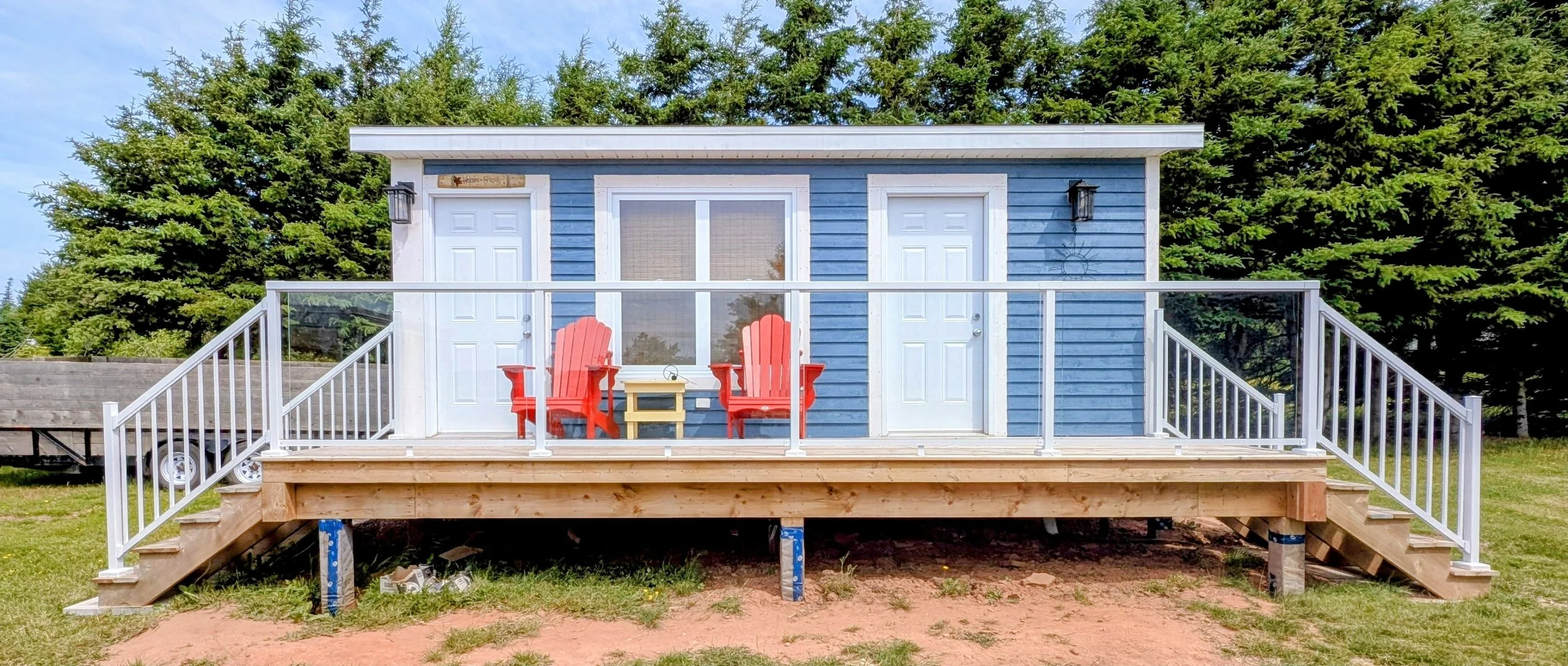 Custom designed and built glass and white aluminum railings for cottage owner in Long River, PEI.