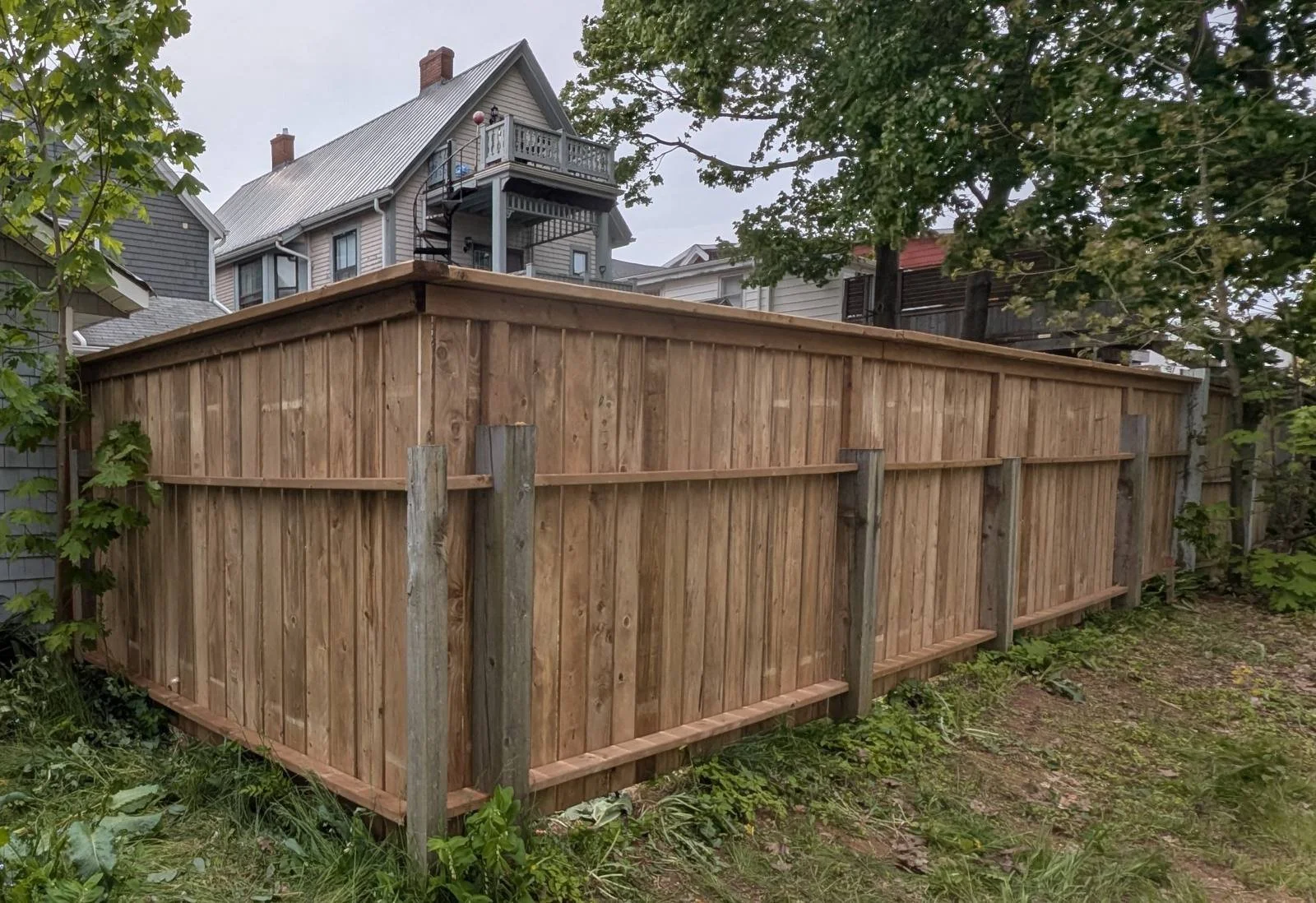 Custom pressure-treated wooden fence built in Charlottetown, PEI