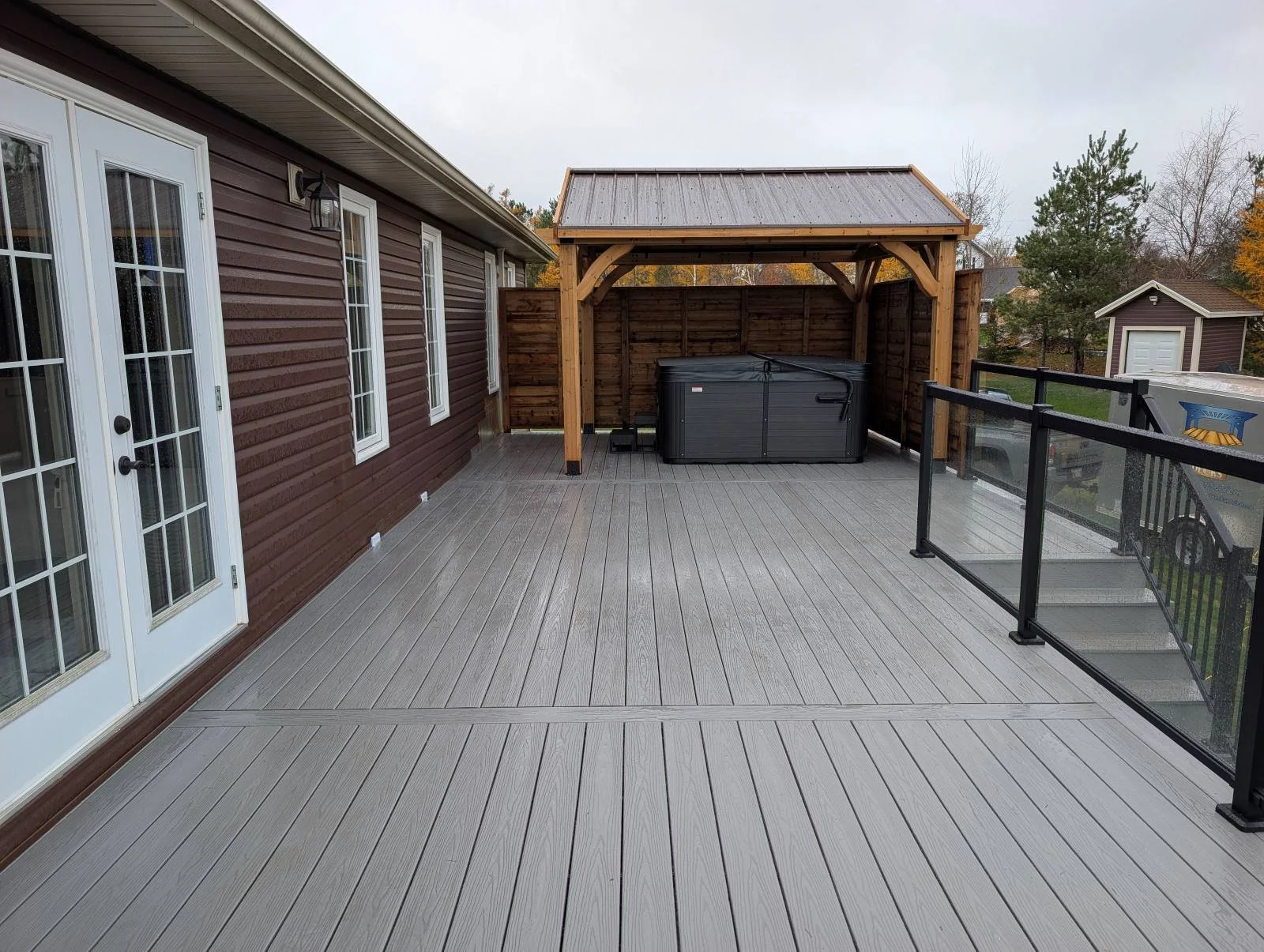 Custom designed and built glass and black aluminum railings on composite deck built for home owner in Cornwall, PEI.