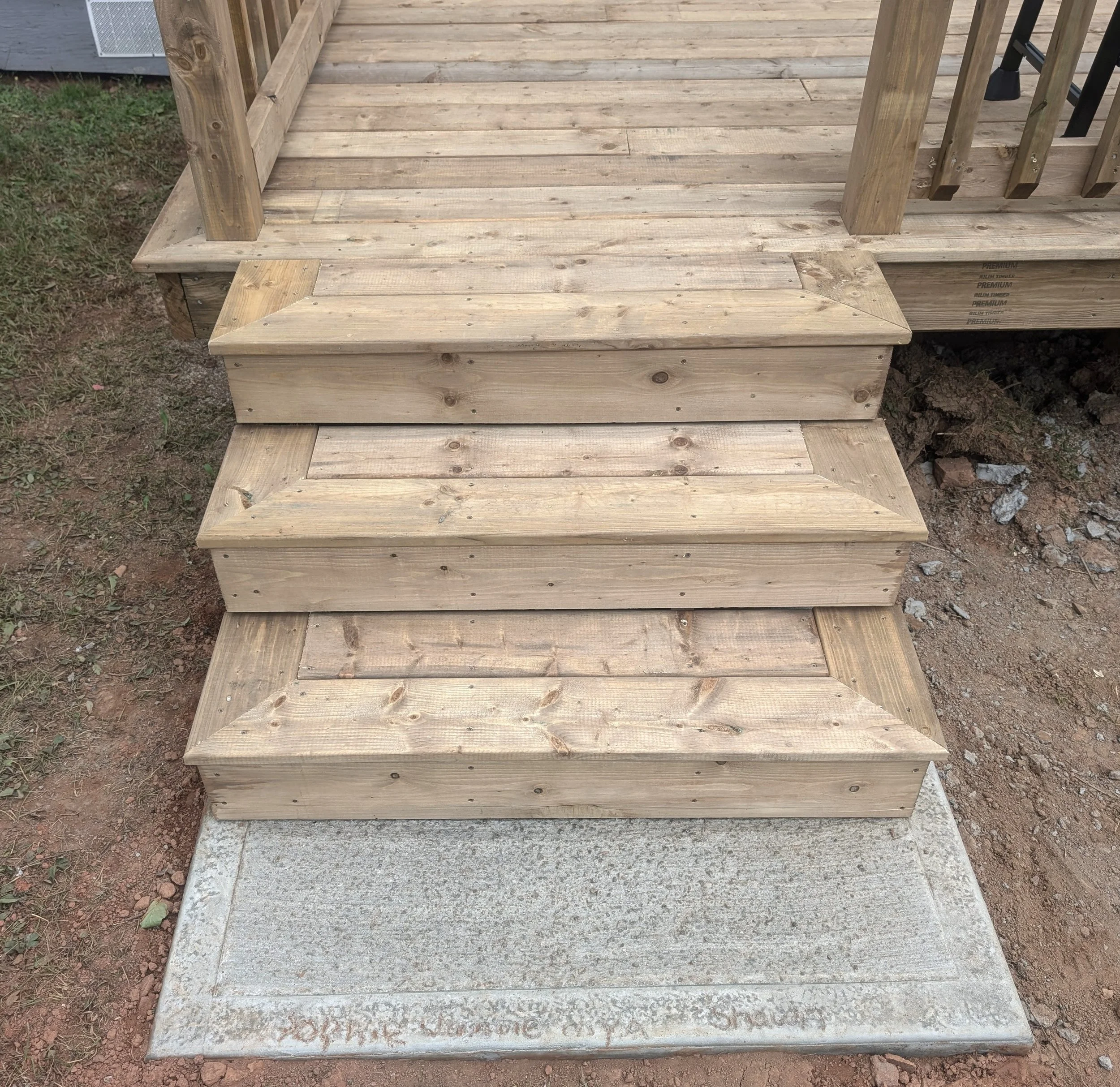Custom design and built, pressure treated, wooden deck with stairs and wood railing built for homeowner in Stanley Bridge, PEI