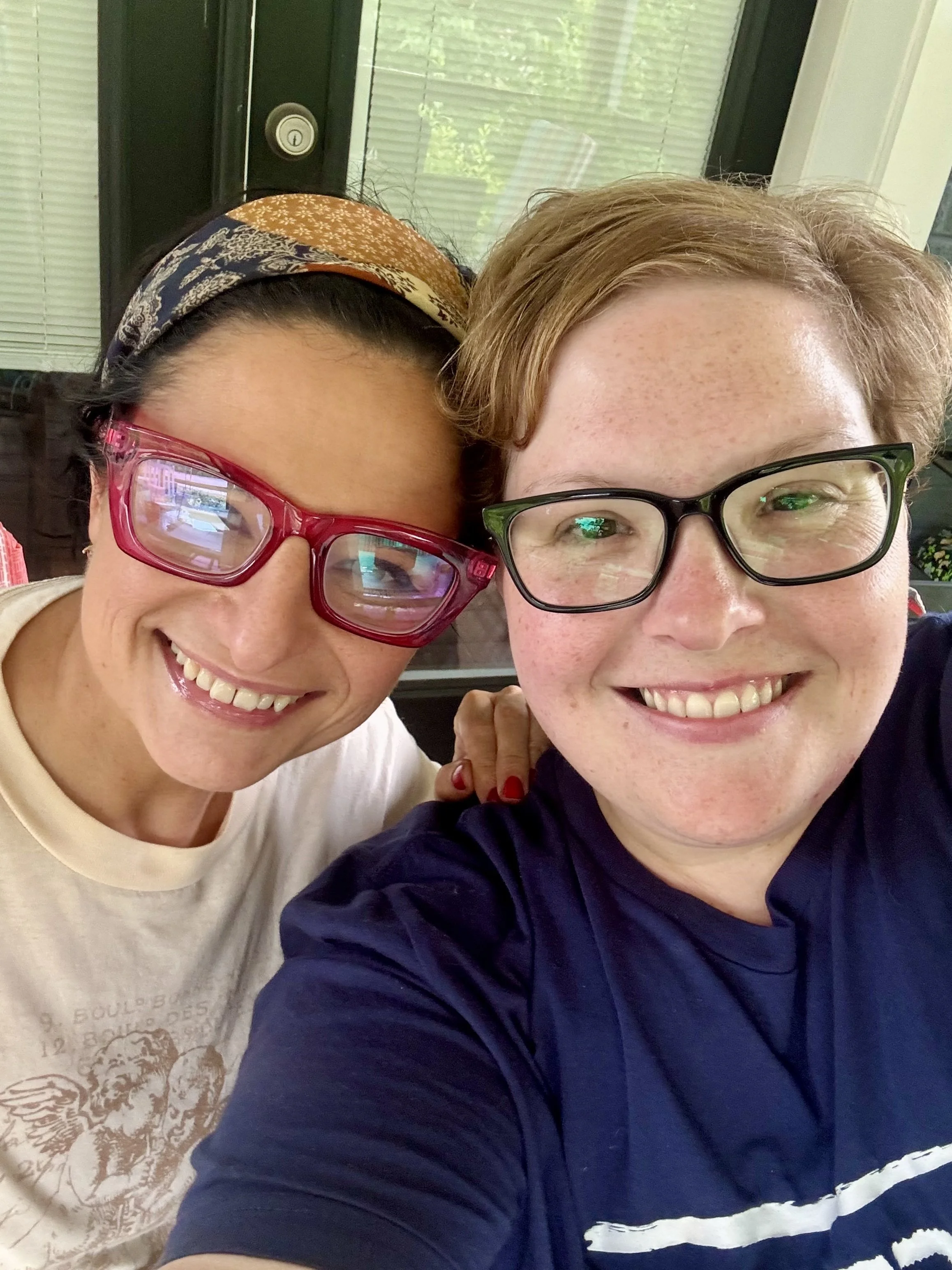 Two women smiling at the camera.