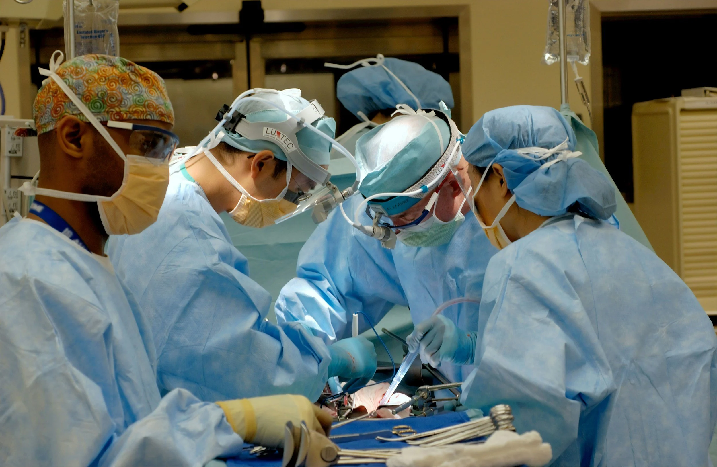 Healthcare professionals performing surgery in an operating room.