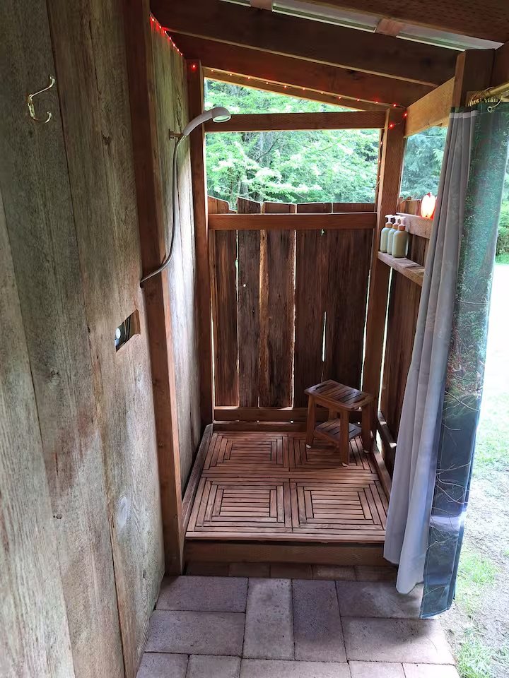 Complete with a fresh air, instant hot water shower with a beautiful cedar surround.