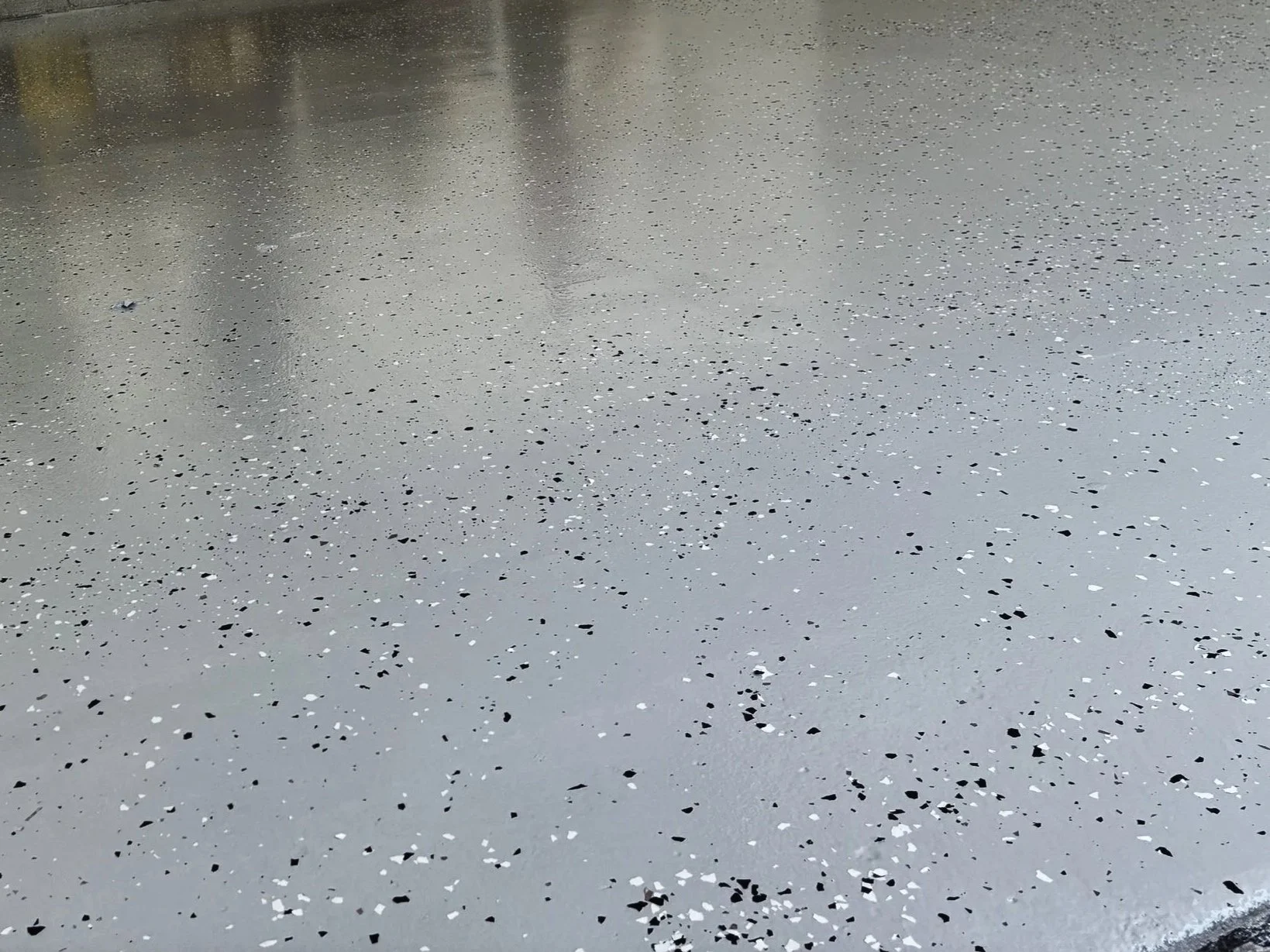 Polished terrazzo floor with black, white, and gray chips
