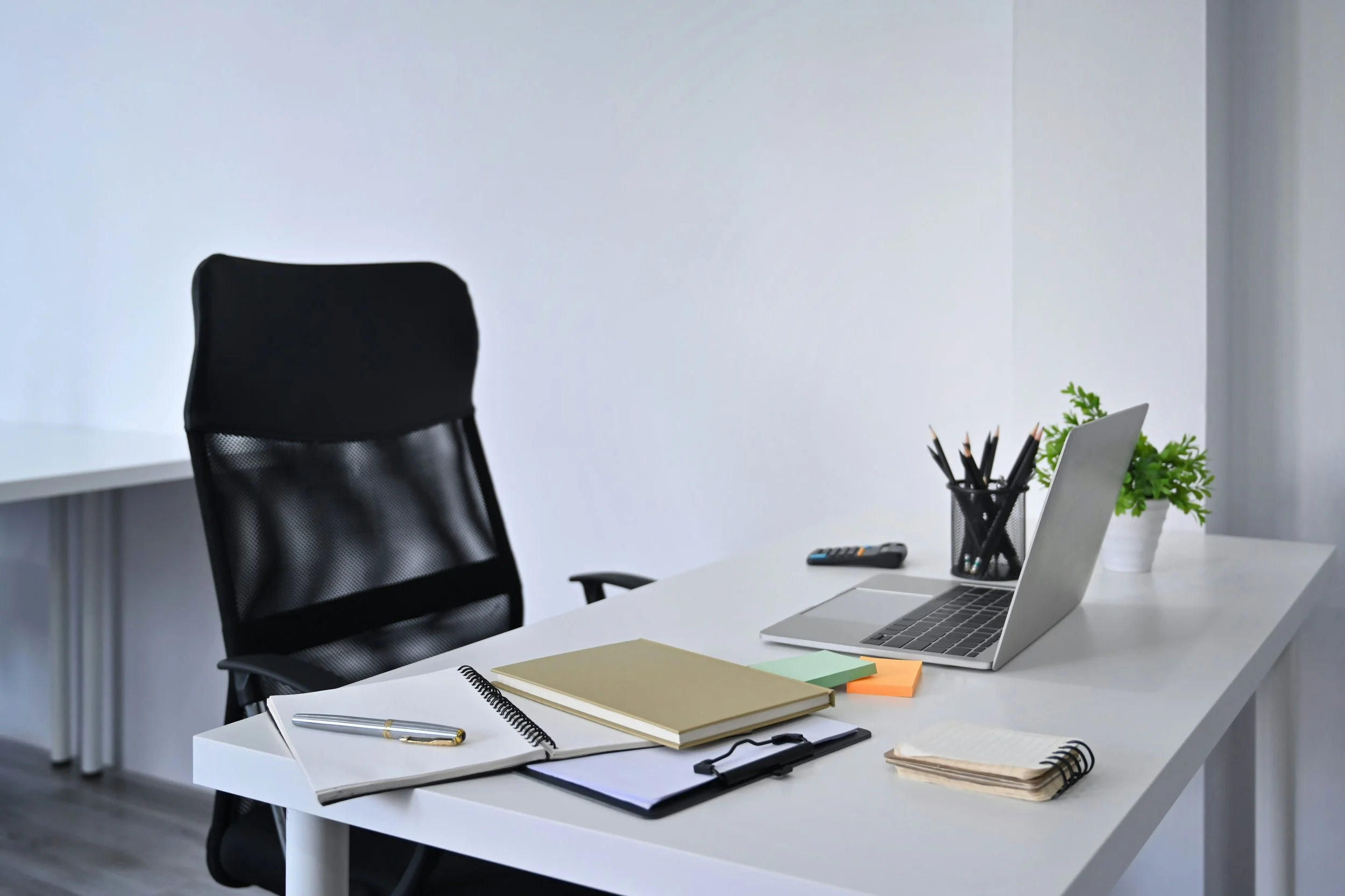 Desk with a notepad and documents in a professional office
