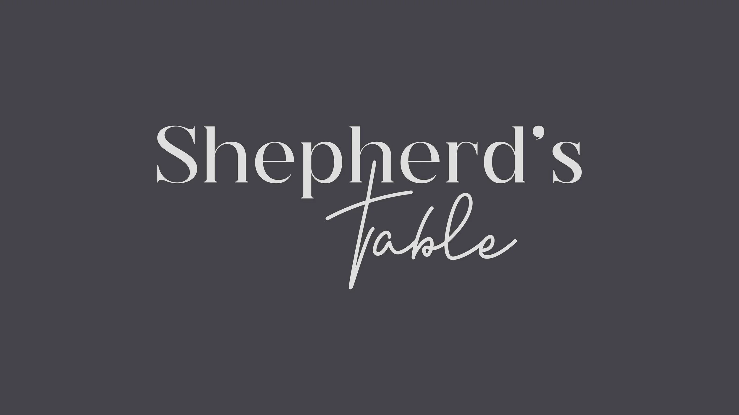 Text graphic with a dark gray background that reads "Shepherd's Table" in large white serif and cursive font.