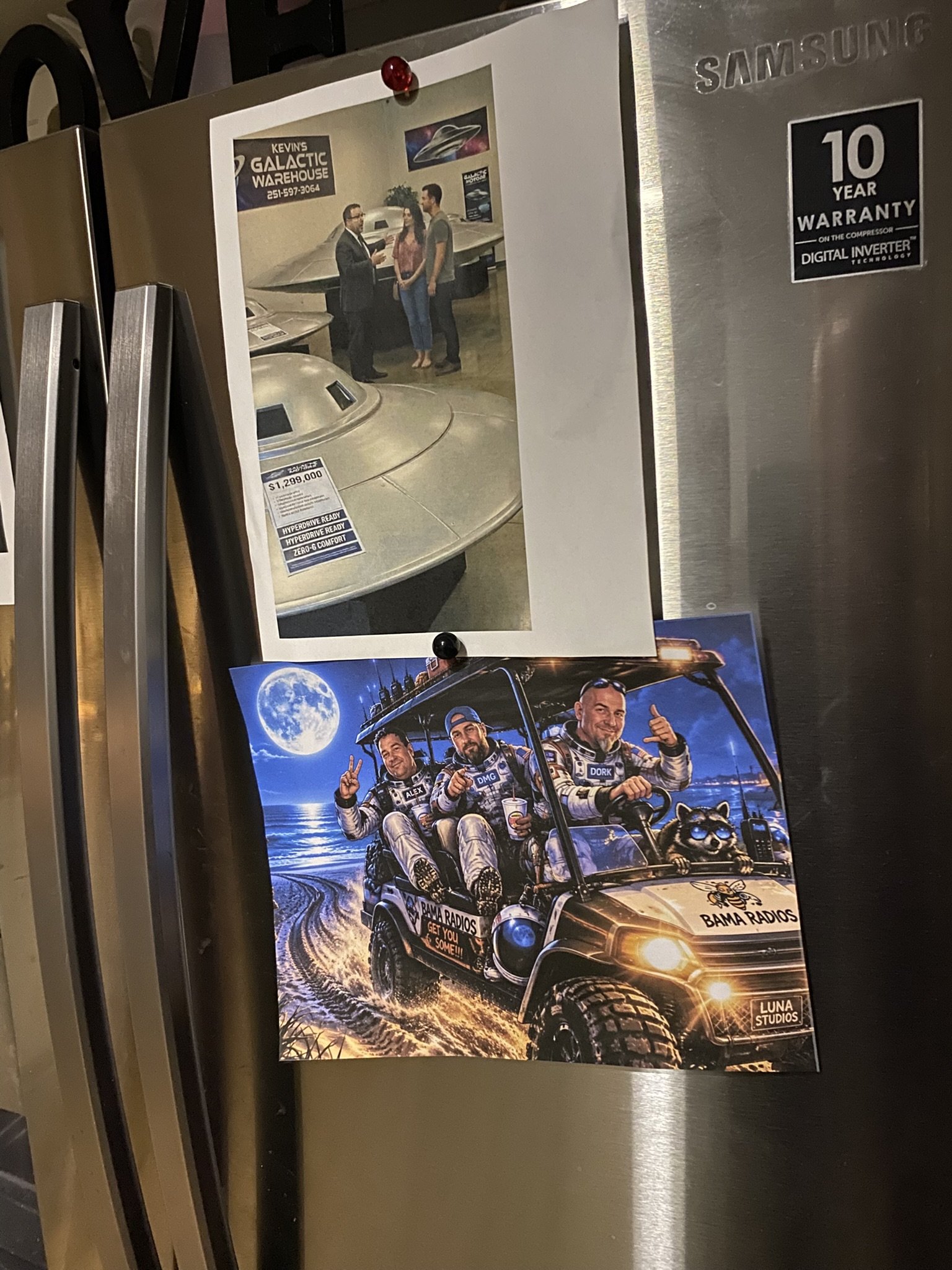 A poster attached to a refrigerator showing three men in astronaut suits riding in a golf cart with a dog, with a night sky and moon in the background.