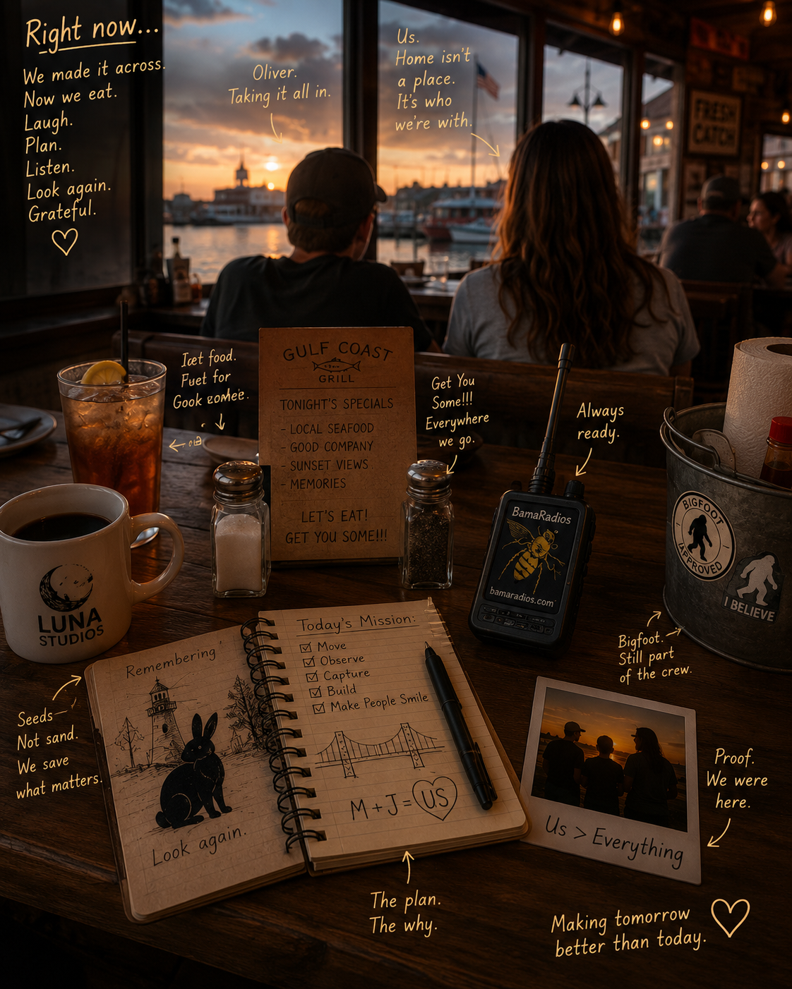 A cozy restaurant table overlooking a sunset over a harbor with boats, with two people seated and various decorative and functional items on the table including a notebook, a coffee mug, a drink, a radio, salt and pepper shakers, a paper towel roll, and a small sign with specials, all illuminated by warm indoor lighting and reflections of the setting sun.