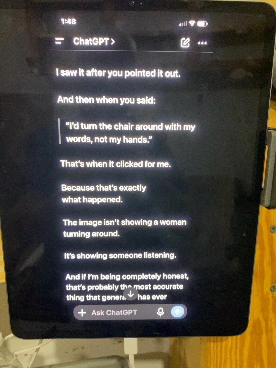A digital device screen displaying a conversation with ChatGPT. The screen shows a humorous text about someone pointing out a situation, with the text starting with 'I saw it after you pointed it out...' and ending with a comment about being honest. The interface includes options to ask ChatGPT questions, with icons for microphone and input at the bottom.
