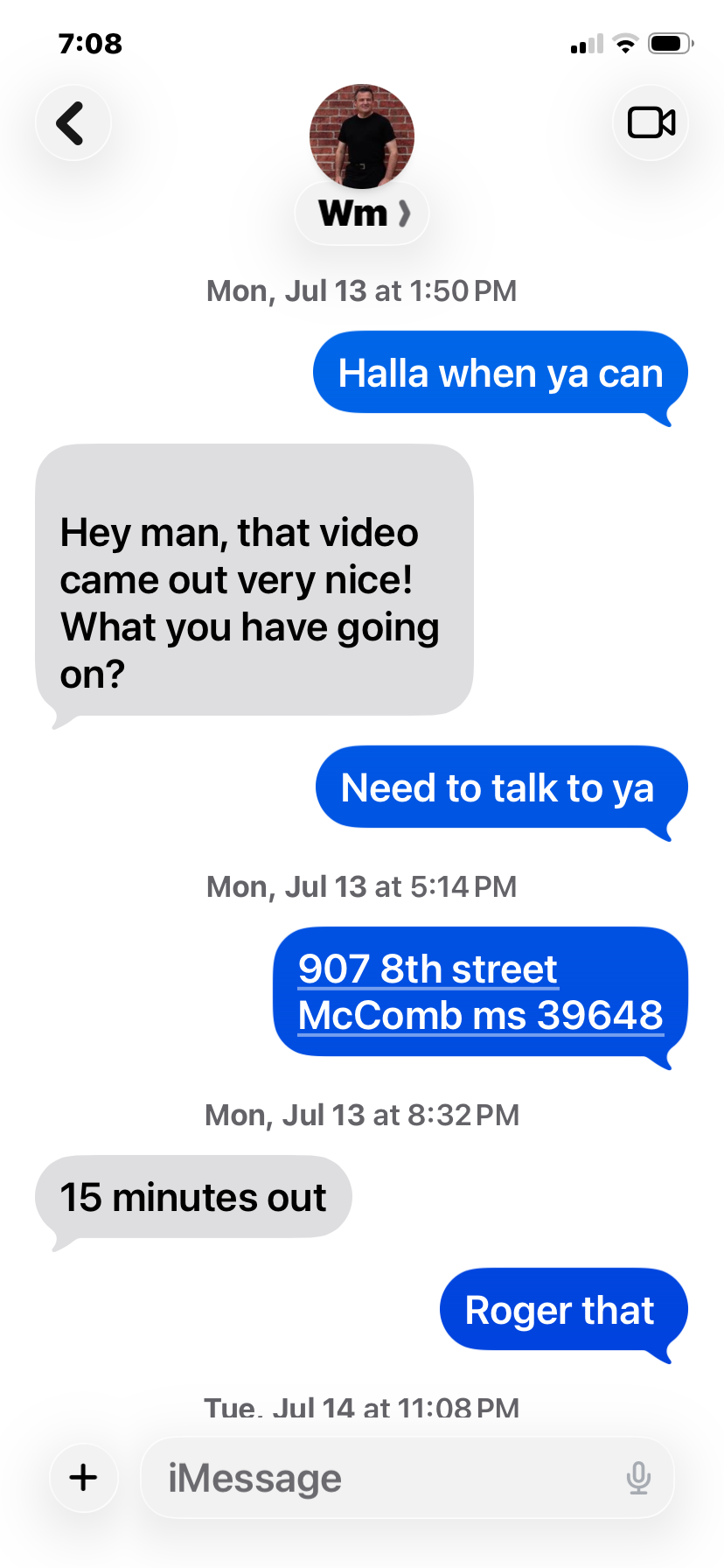 A screenshot of a text message conversation on a mobile phone. The conversation includes messages about meeting location and time, with details of an address and mentions of being 15 minutes out.