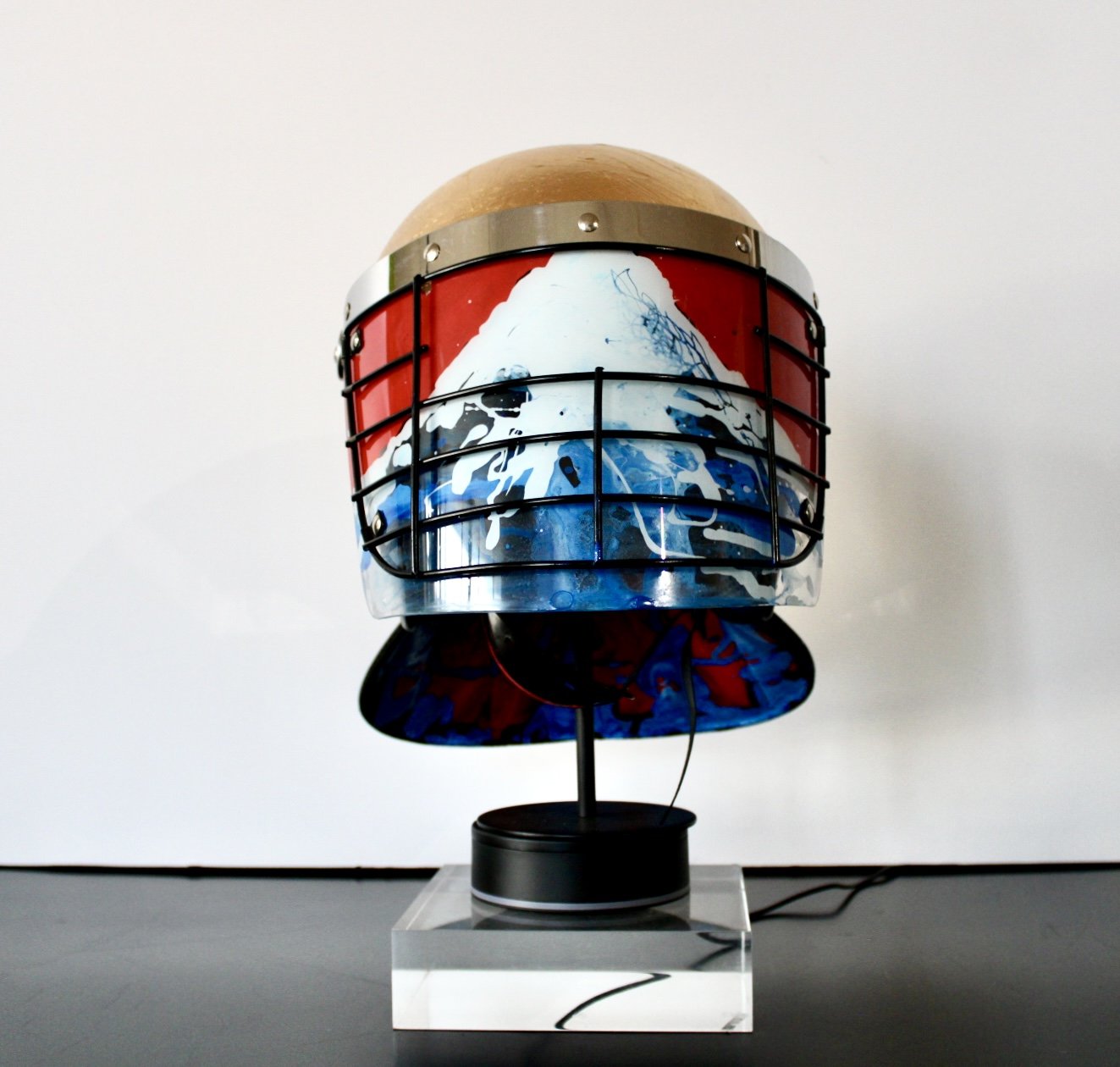"When the Mountain Blesses the Rain"

Acrylic and Imitation Gold Leaf on Police Riot Helmet
18" x 12" x 10.5"
2024

