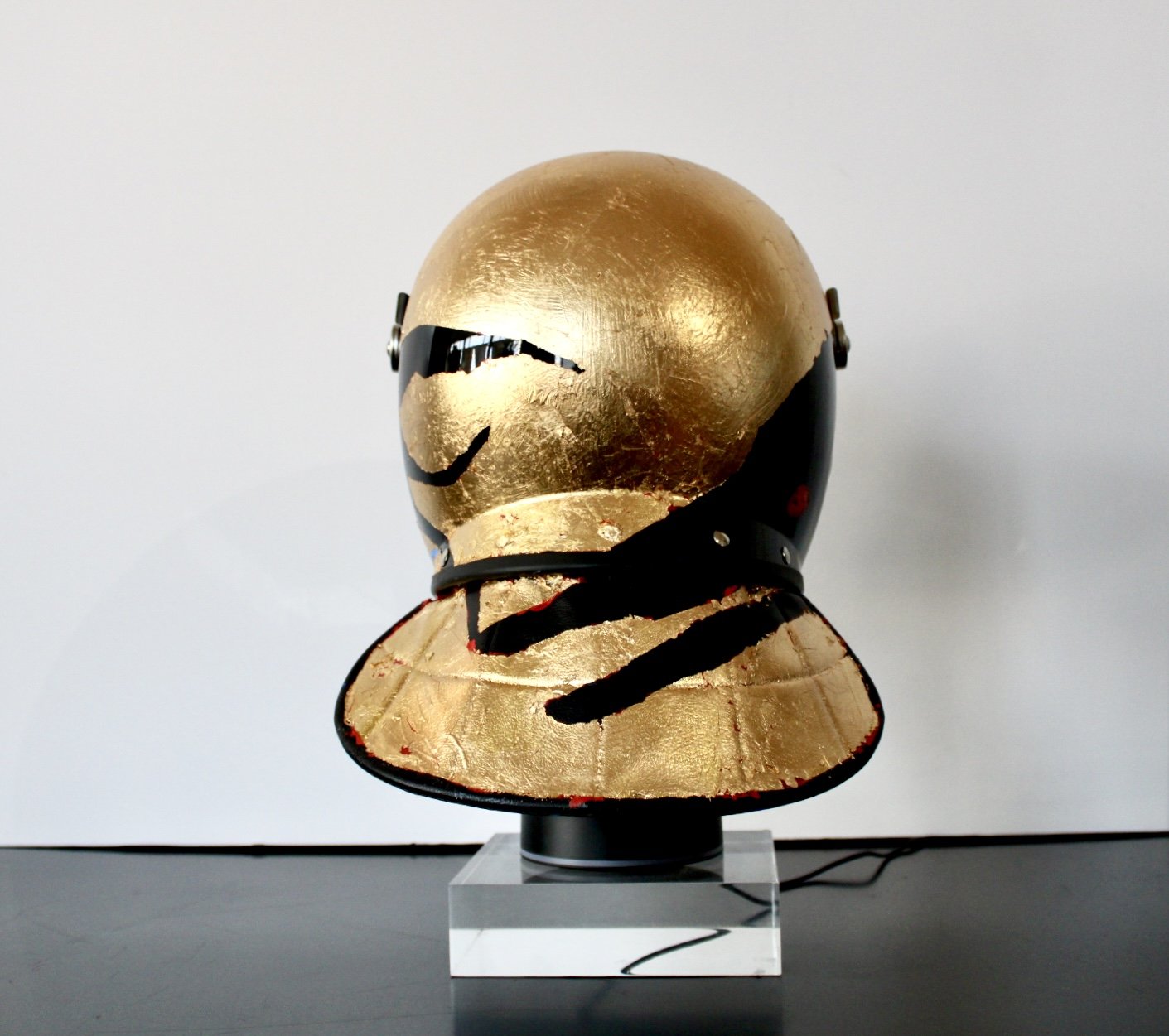 "When the Mountain Blesses the Rain" [rear view]

Acrylic and Imitation Gold Leaf on Police Riot Helmet
18" x 12" x 10.5"
2024
