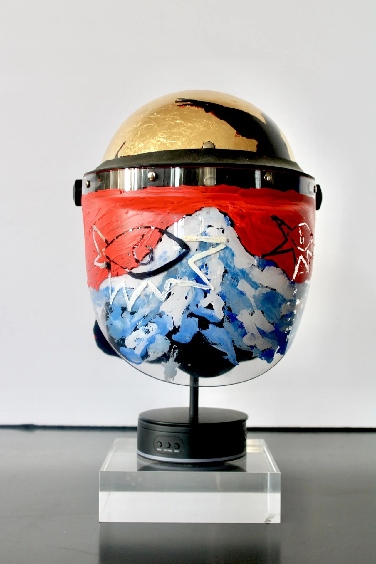 When the  River Runs Red"

Acrylic and Imitation Gold Leaf on Police Riot Helmet
18" x 12" x 10.5"
2024