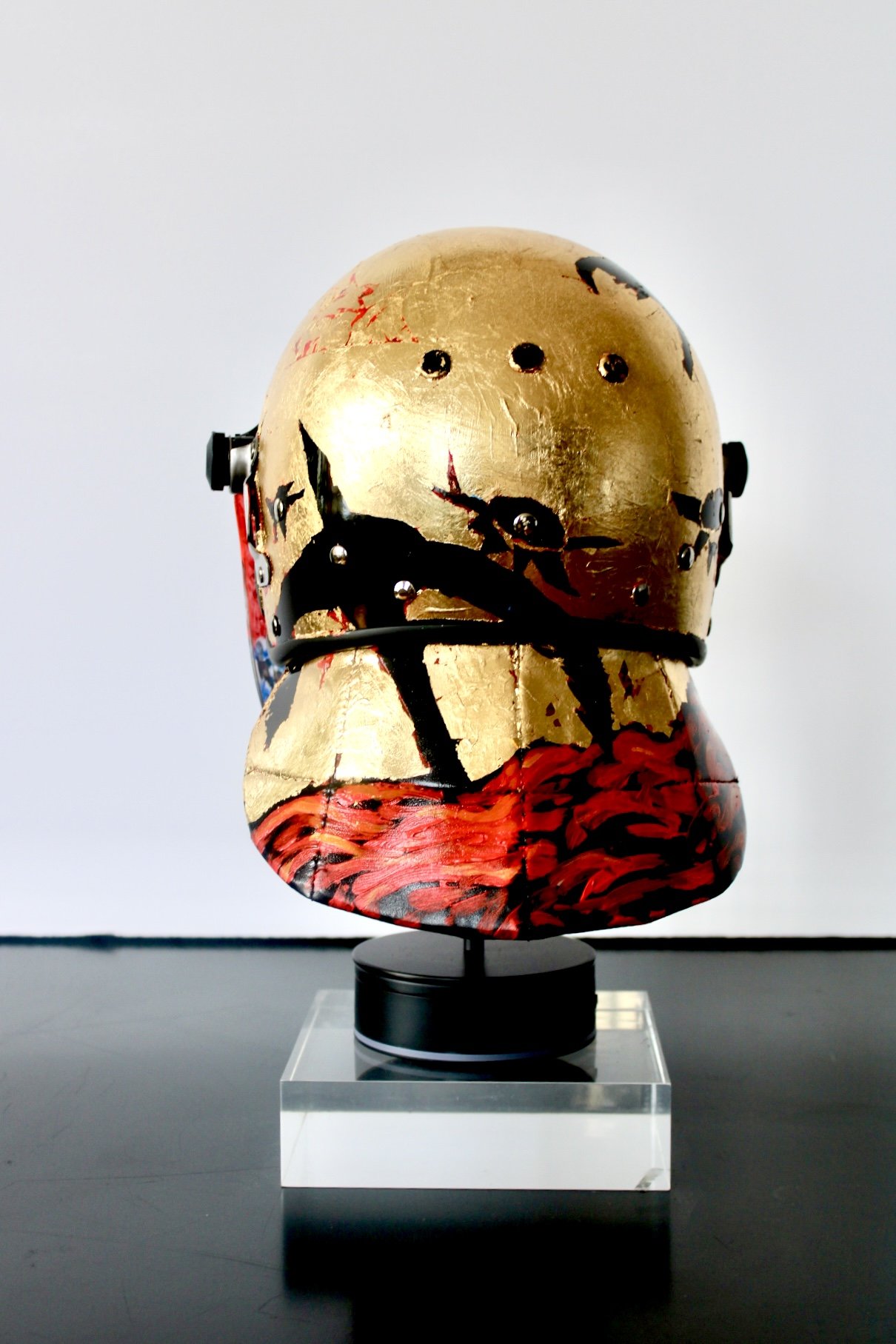 "When the  River Runs Red" [rear view]

Acrylic and Imitation Gold Leaf on Police Riot Helmet
18" x 12" x 10.5"
2024