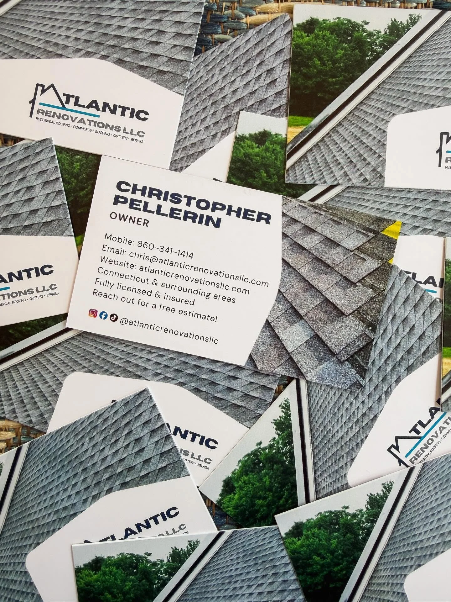 Business cards for Atlantic Renovations LLC showing roofing images and contact information for Christopher Pellerin.