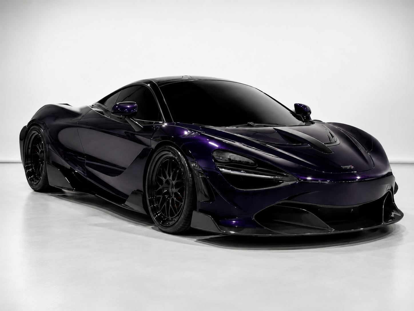 A sleek, black sports car with purple accents and tinted windows, displayed on a plain white background.