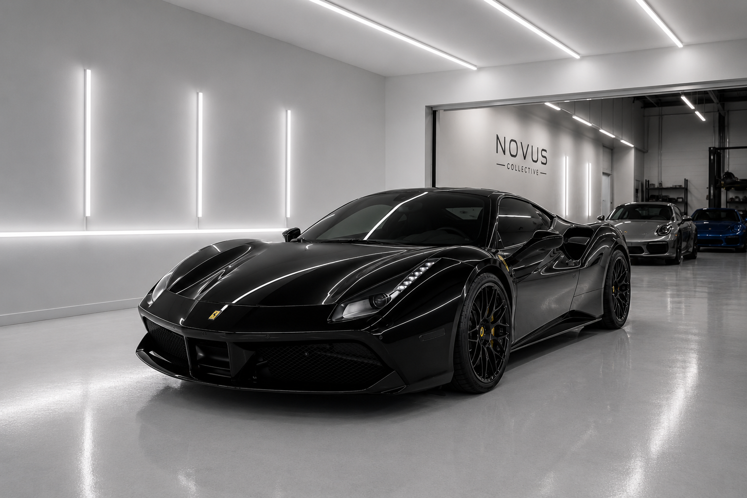 A black Ferrari sports car parked inside a modern showroom with white walls and ceiling, and other luxury cars in the background.