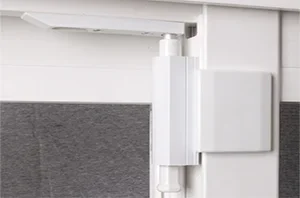 Close-up of a white door hinge and part of the door frame.