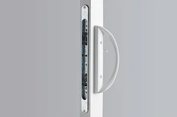 Close-up of a white door handle on a gray door with a modern lock mechanism.