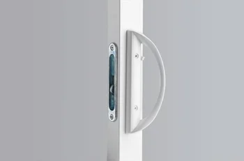 Close-up of a door lock and handle on a white door.